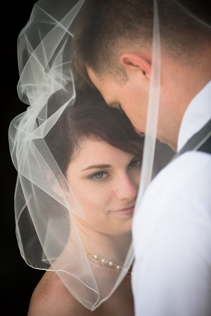 Bride And Groom Portrait Through Veil