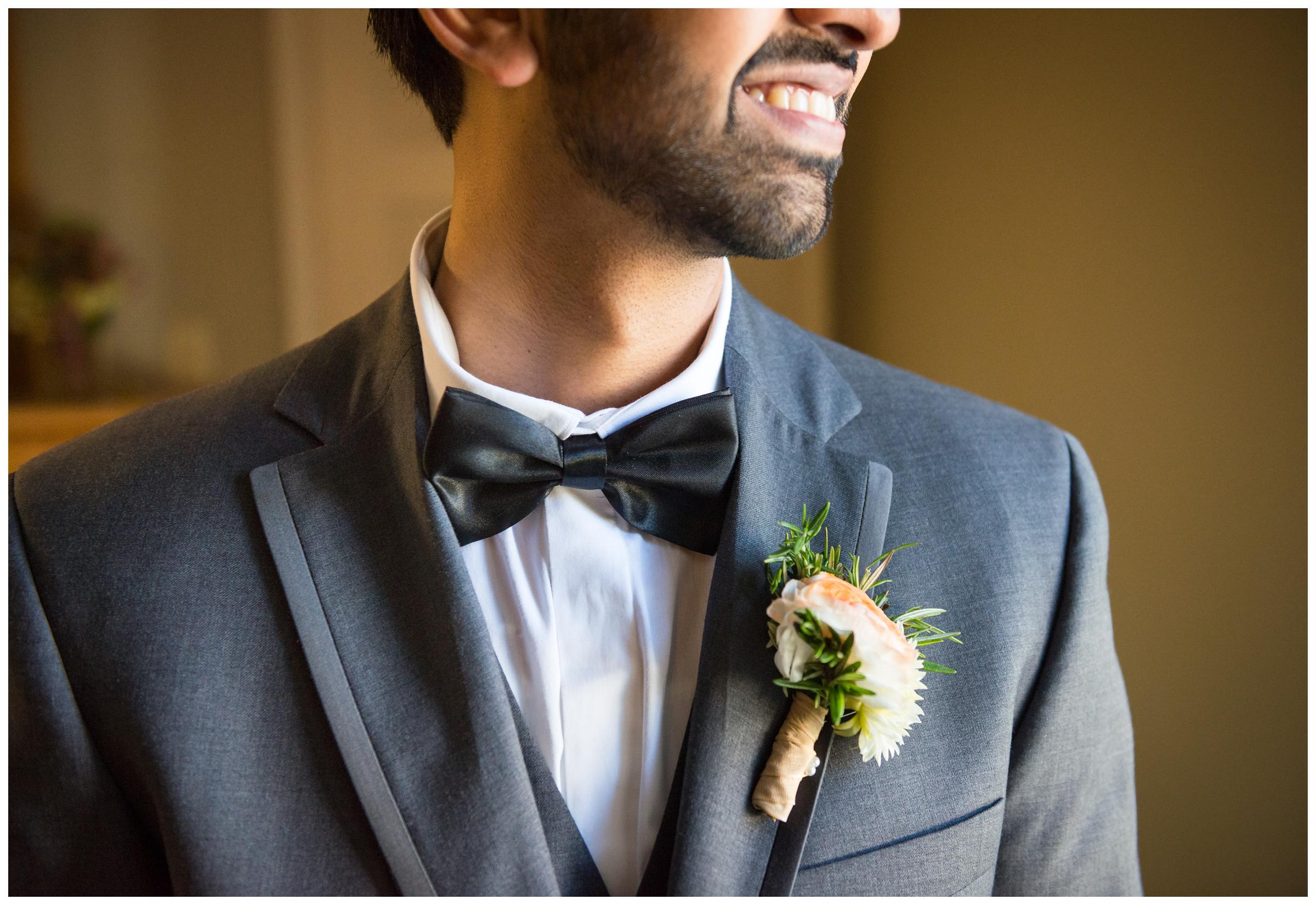 Groom looking out window before wedding ceremony.