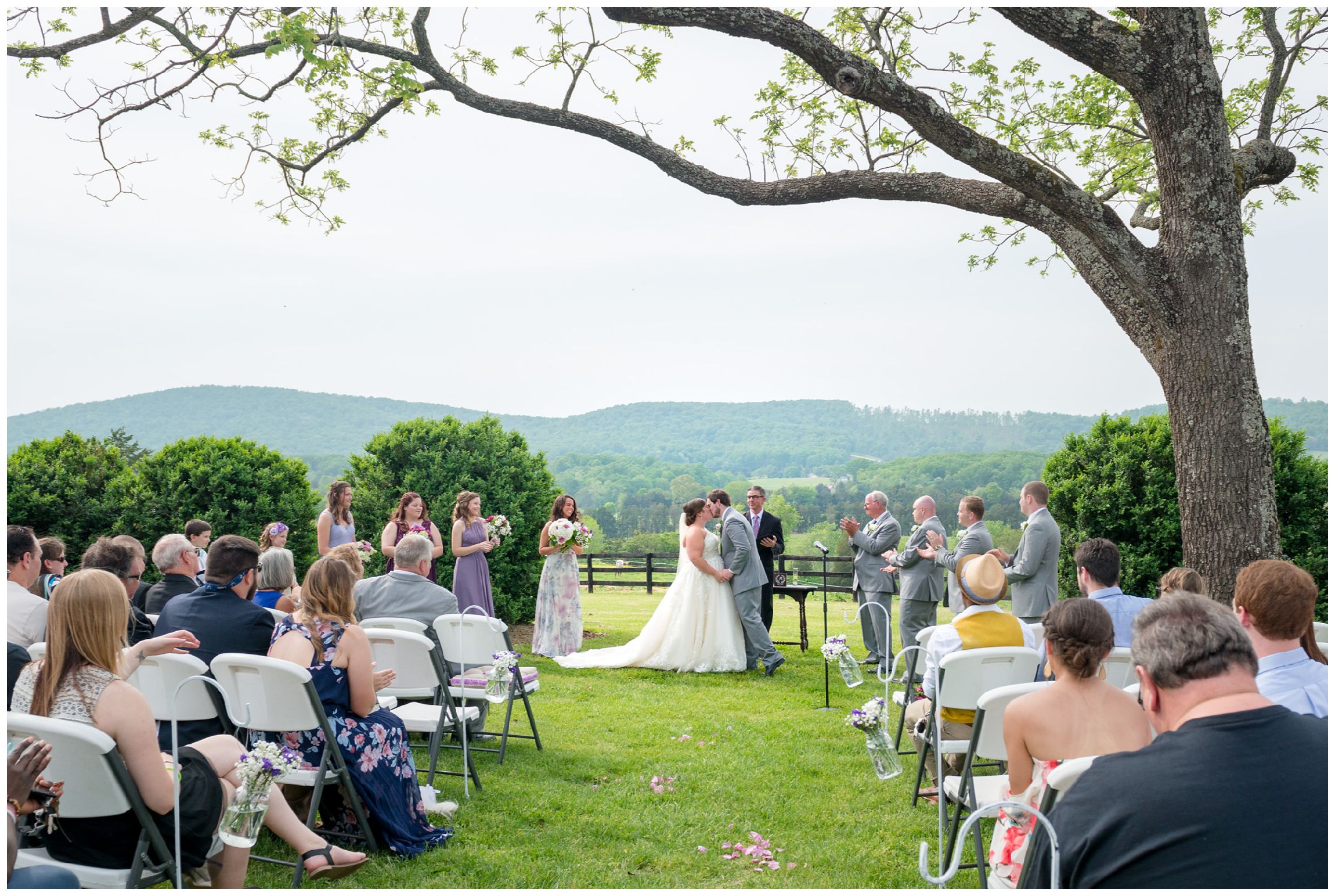 first kiss during rustic spring wedding with mountain views at Wolftrap Farm in Gordonsville, Virginia