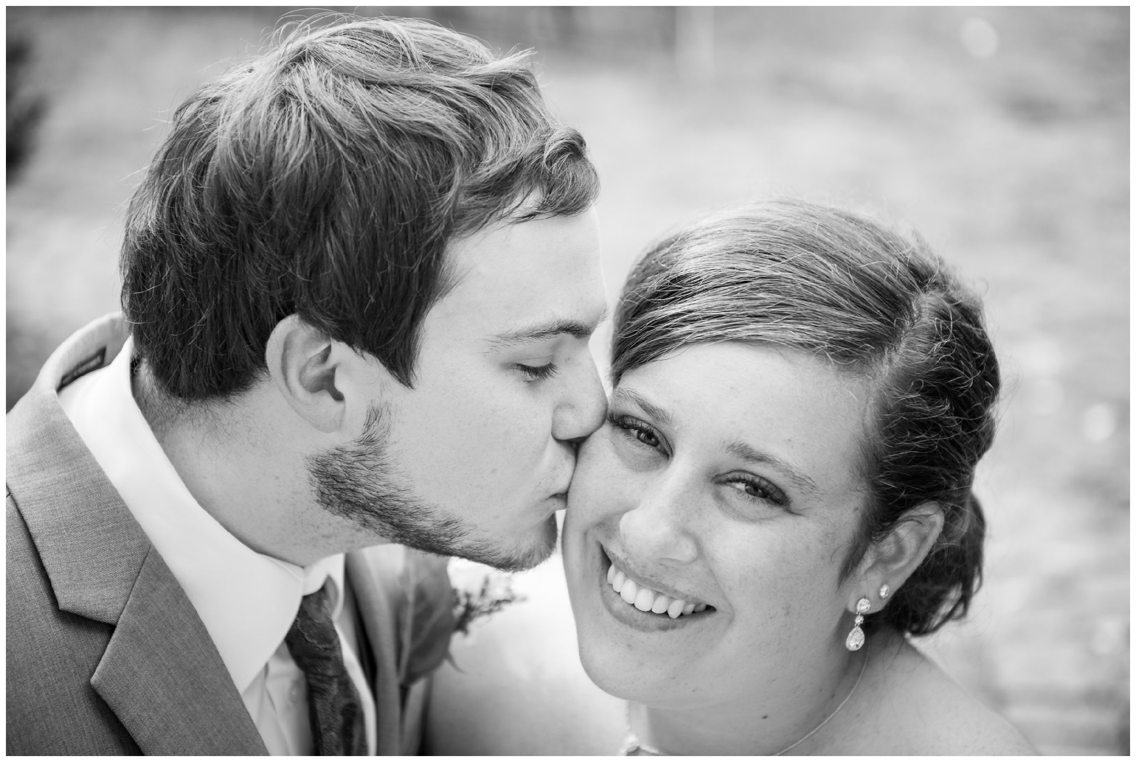 groom kissing bride on wedding day