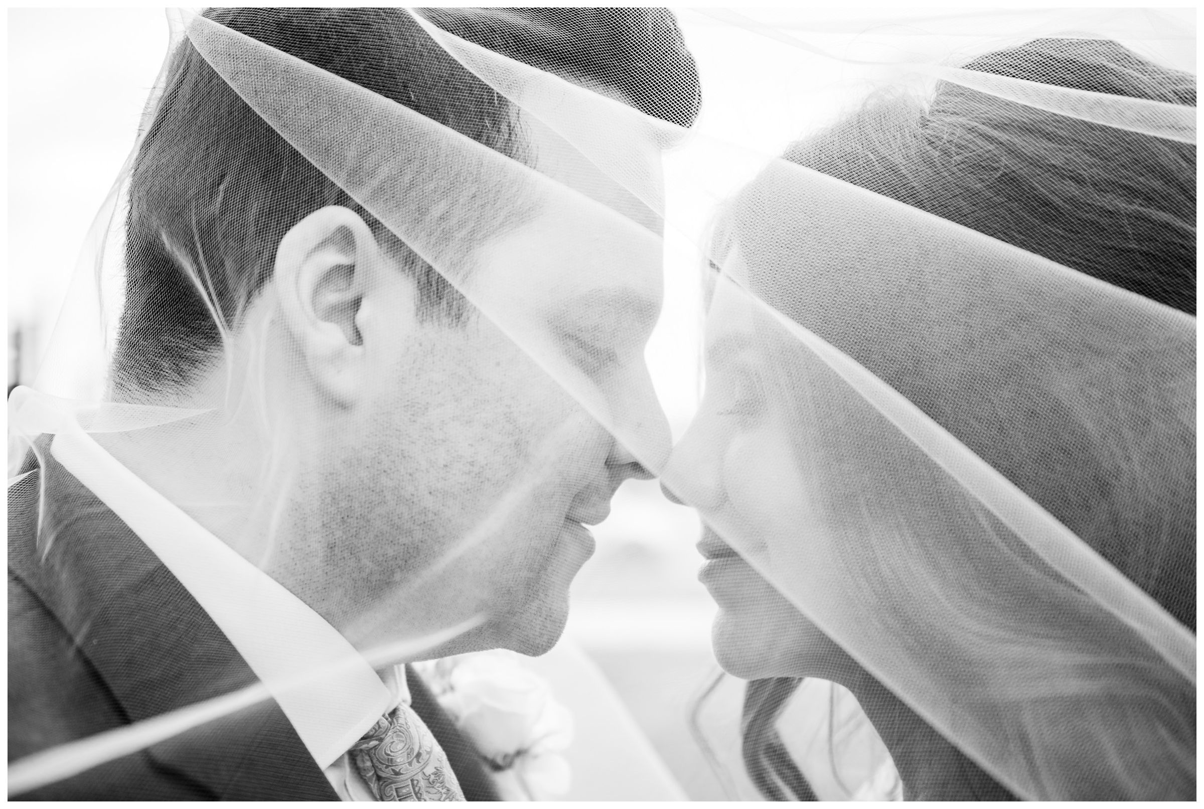 bride and groom under veil during DC monument wedding day