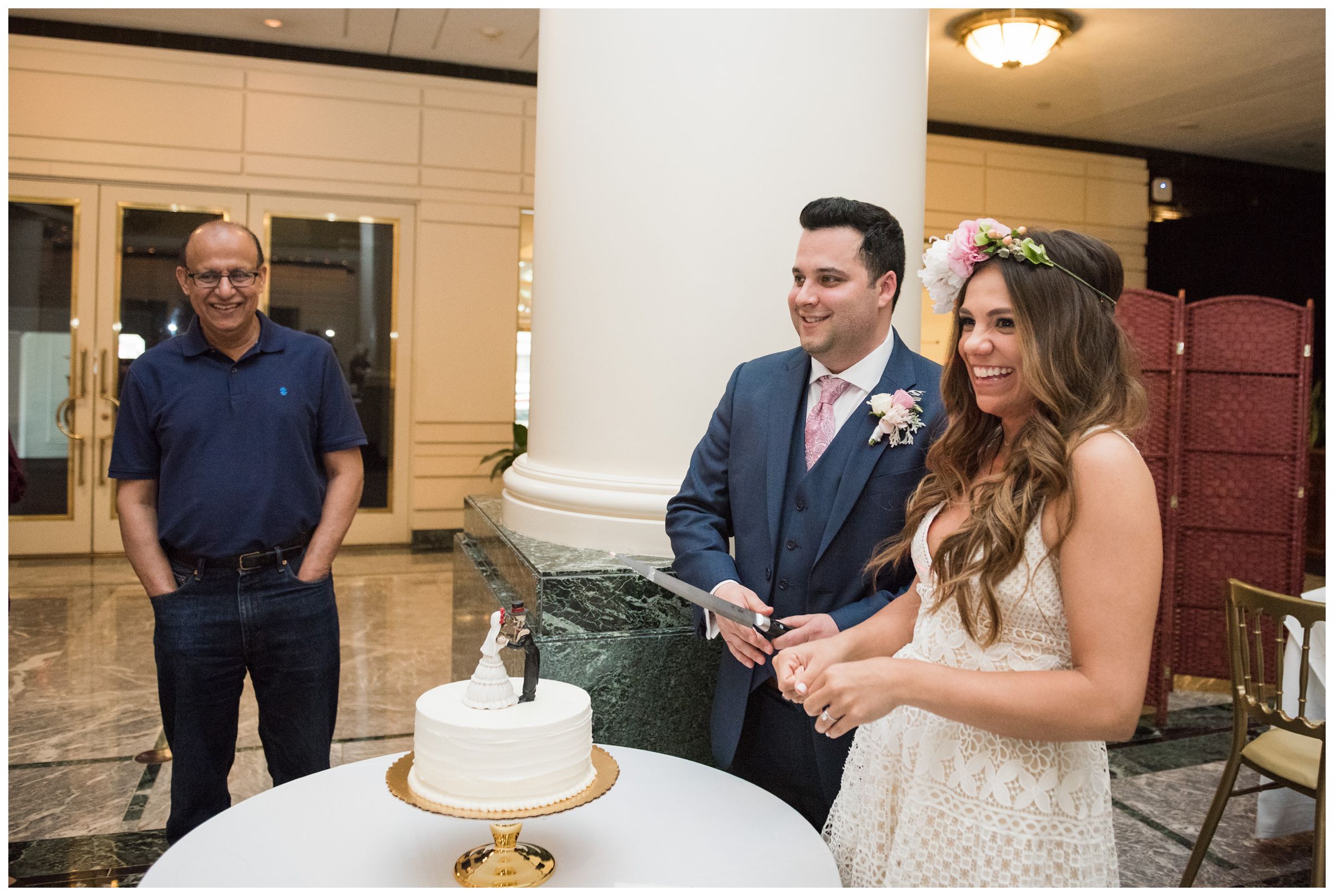 newlyweds cutting cake during intimate wedding reception dinner at Old Ebbitt Grill in Washington, D.C.