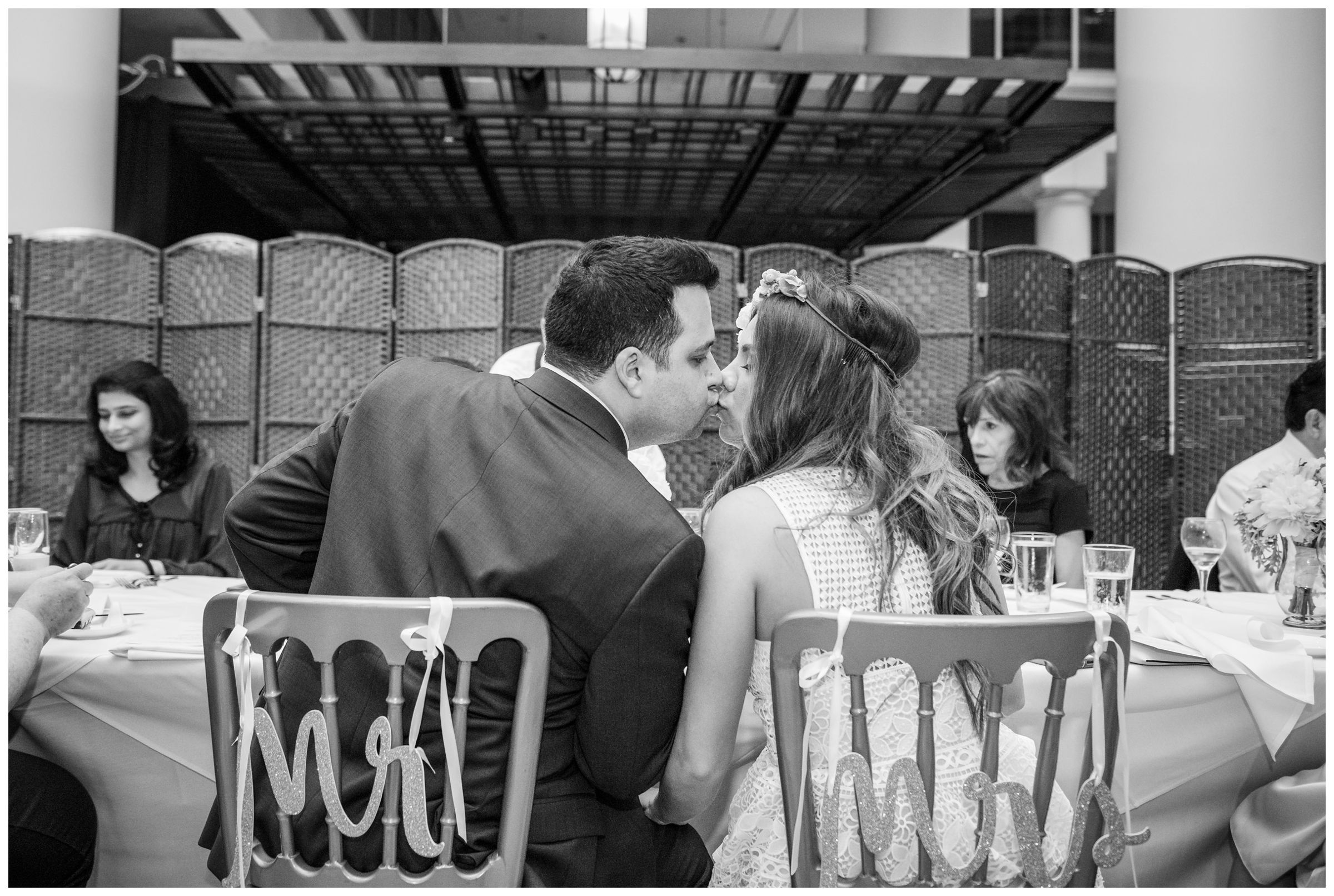 bride and groom kissing during intimate wedding reception dinner at Old Ebbitt Grill in Washington, D.C.