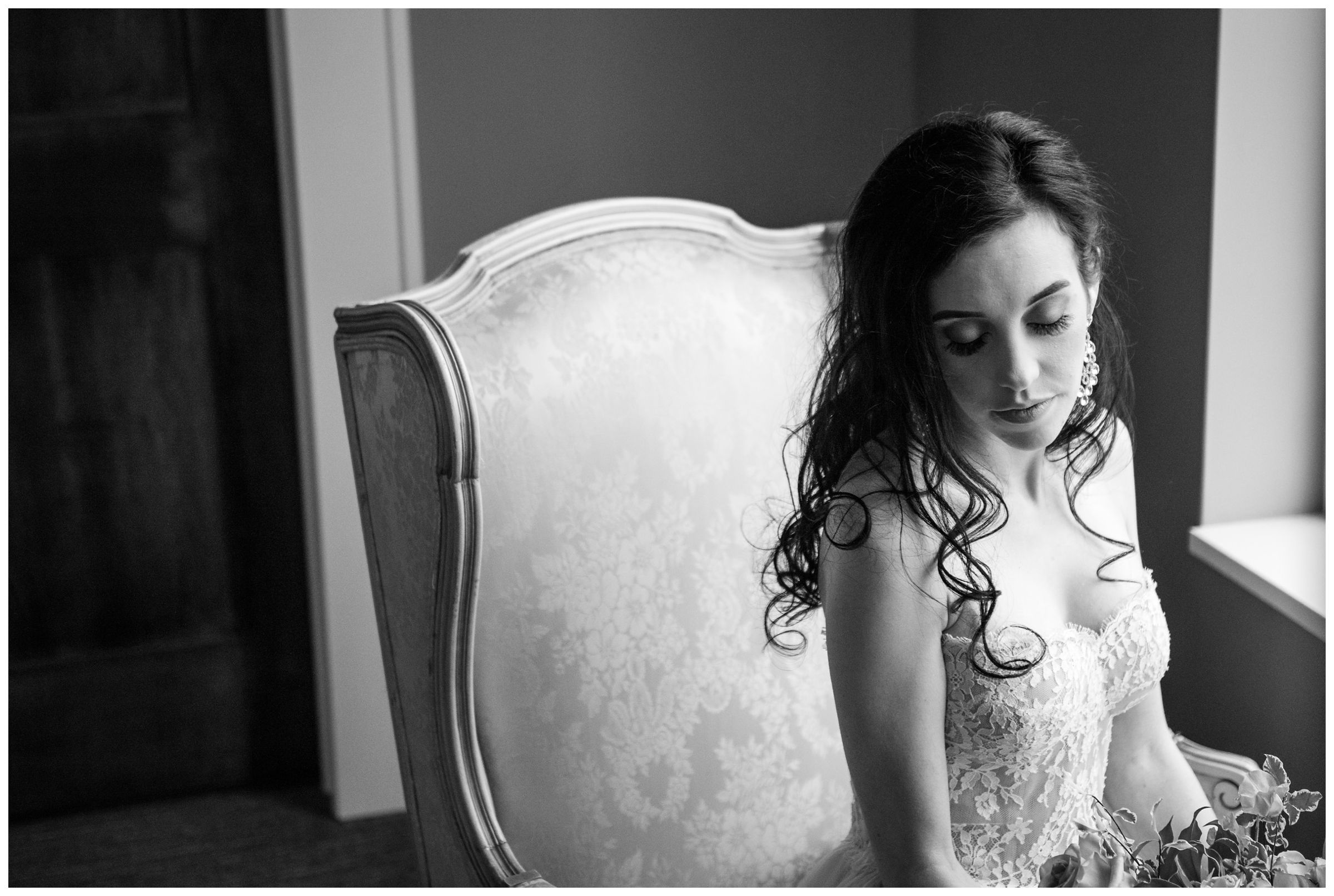 bride sitting in armchair in window light