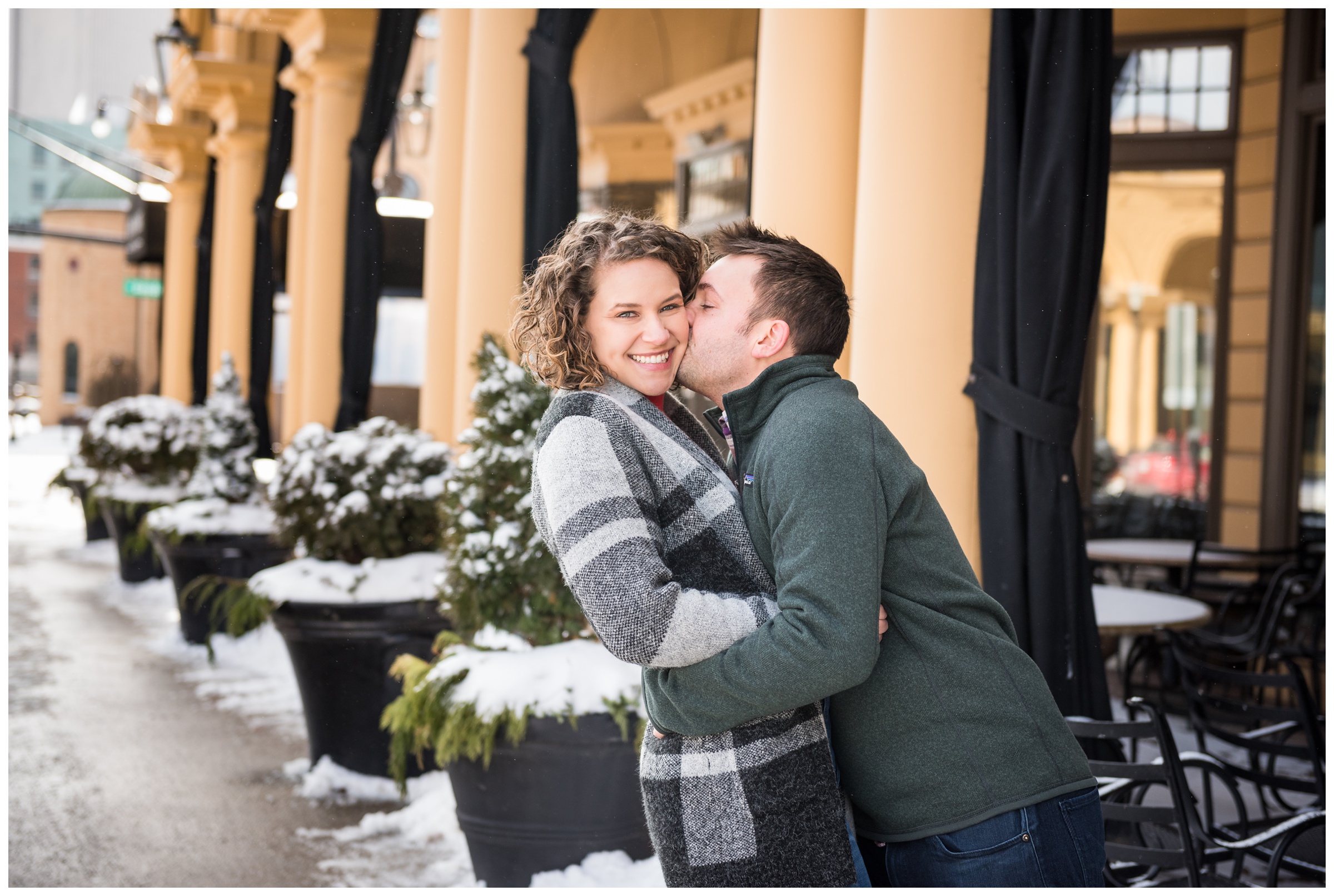 engaged couple on High Street in the Short North neighborhood of Columbus, Ohio during snowy winter engagement session