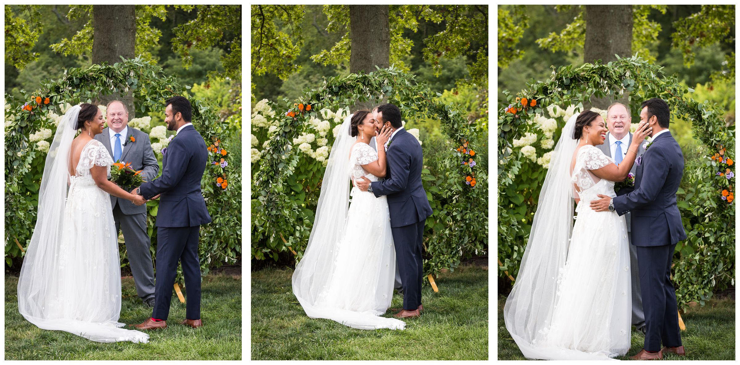 wedding ceremony first kiss in front of floral moongate arch during rustic wedding at Jorgensen Farms Historic Barn