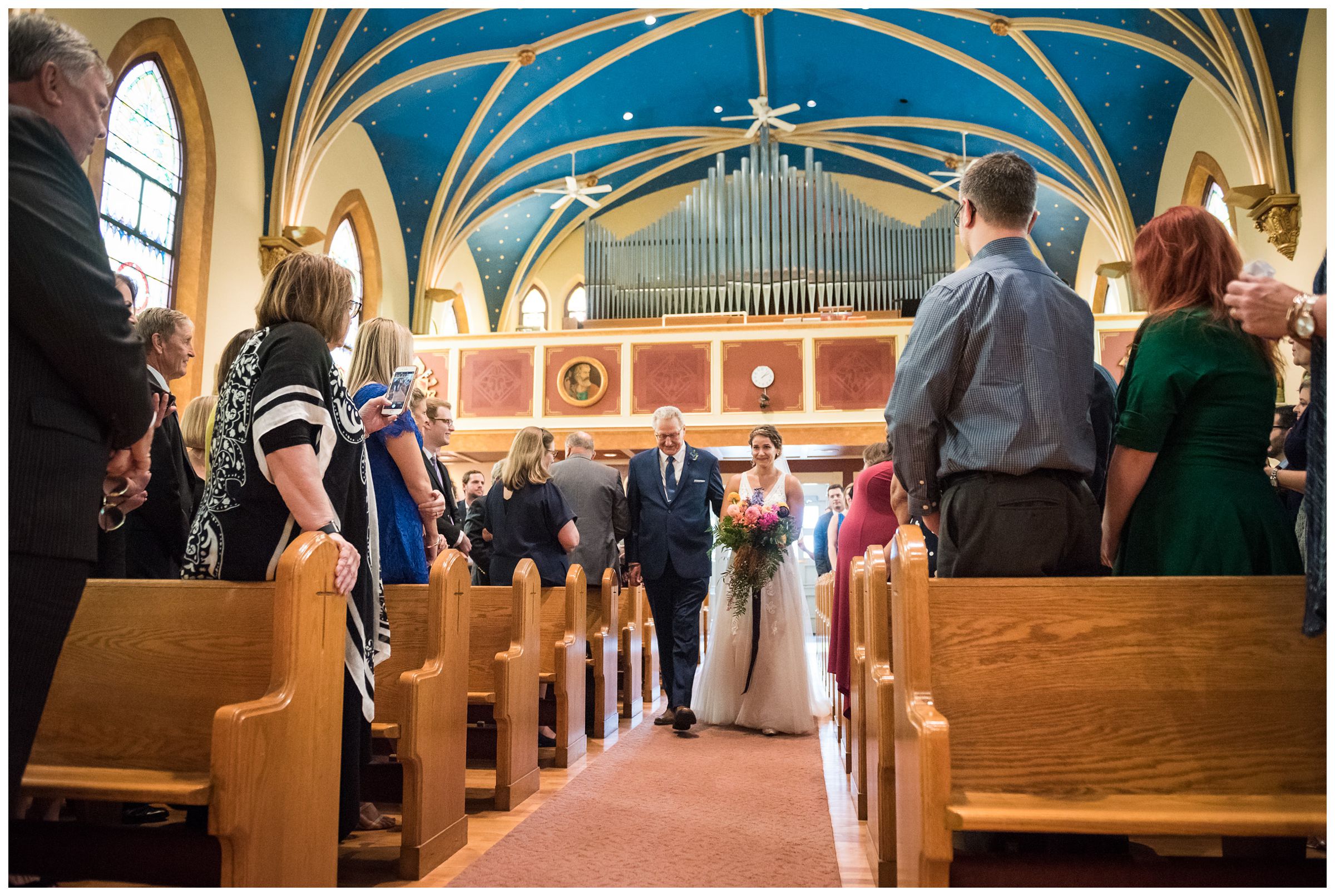 bride walking down the aisle during wedding ceremony at St. John the Baptist Catholic Church in Columbus, Ohio