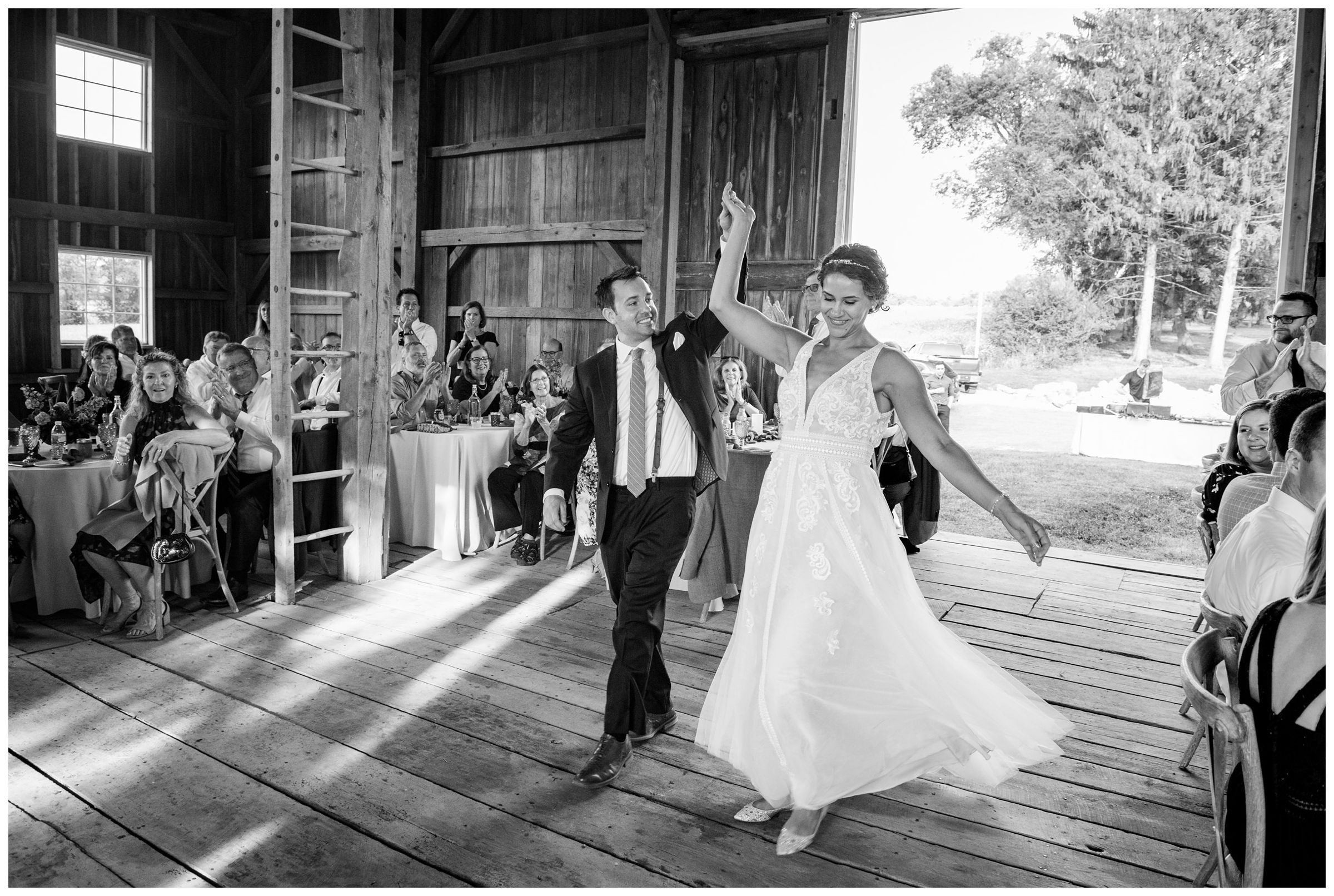 bride and groom entering rustic barn wedding reception in Lancaster Ohio