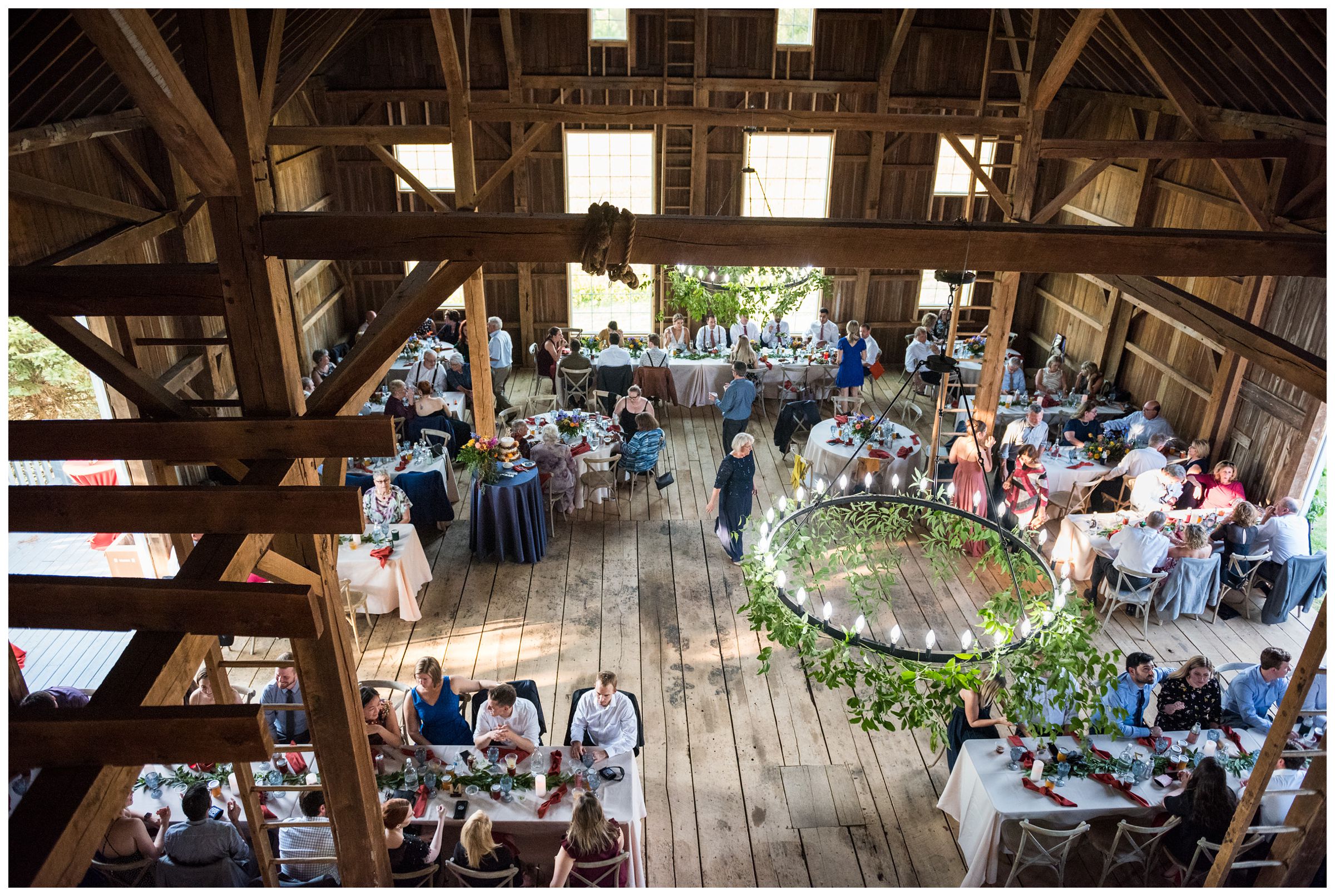 rustic barn wedding reception with greenery at family farm in Lancaster, Ohio