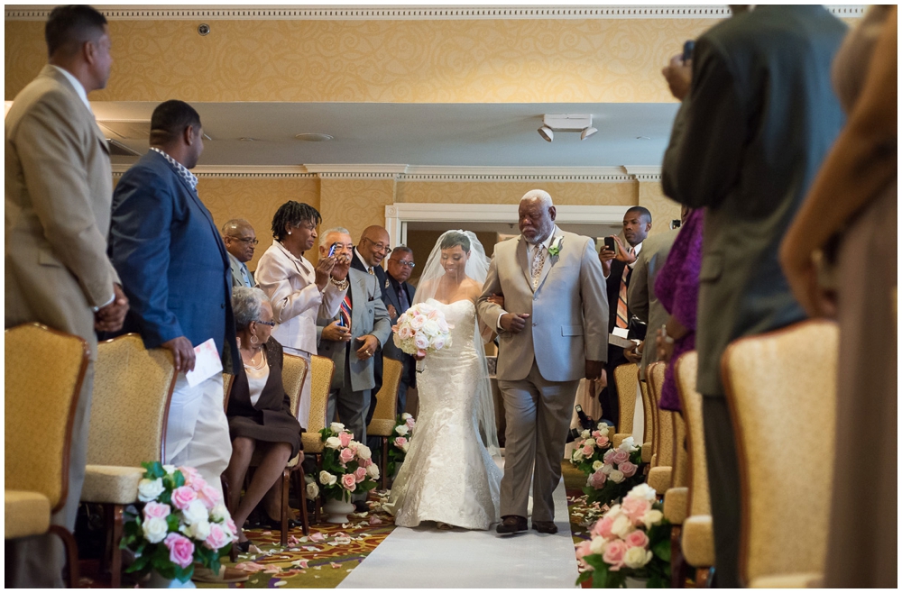 bride walking down aisle with father