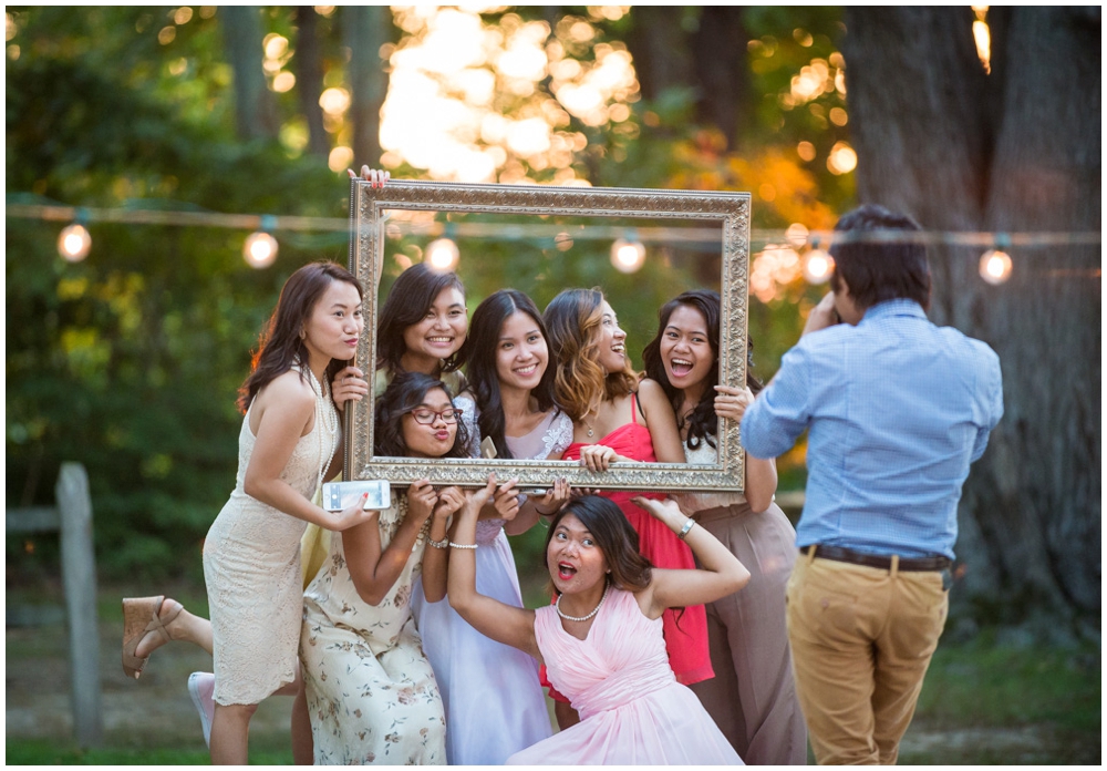 bride taking photos with friends at wedding reception