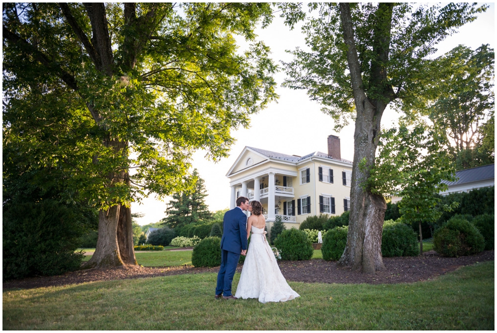 bride and groom portrait in front of manor house