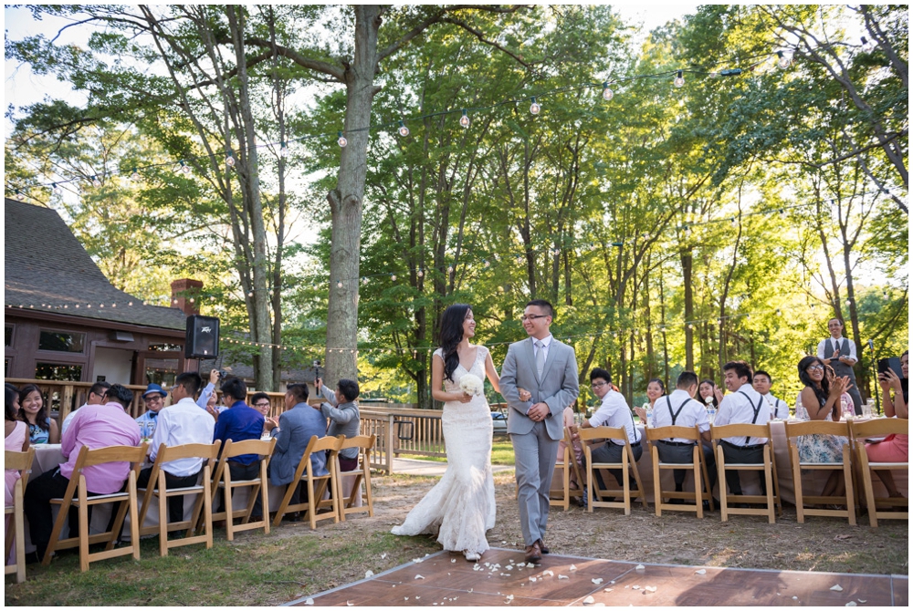 bride and groom entering rustic wedding reception