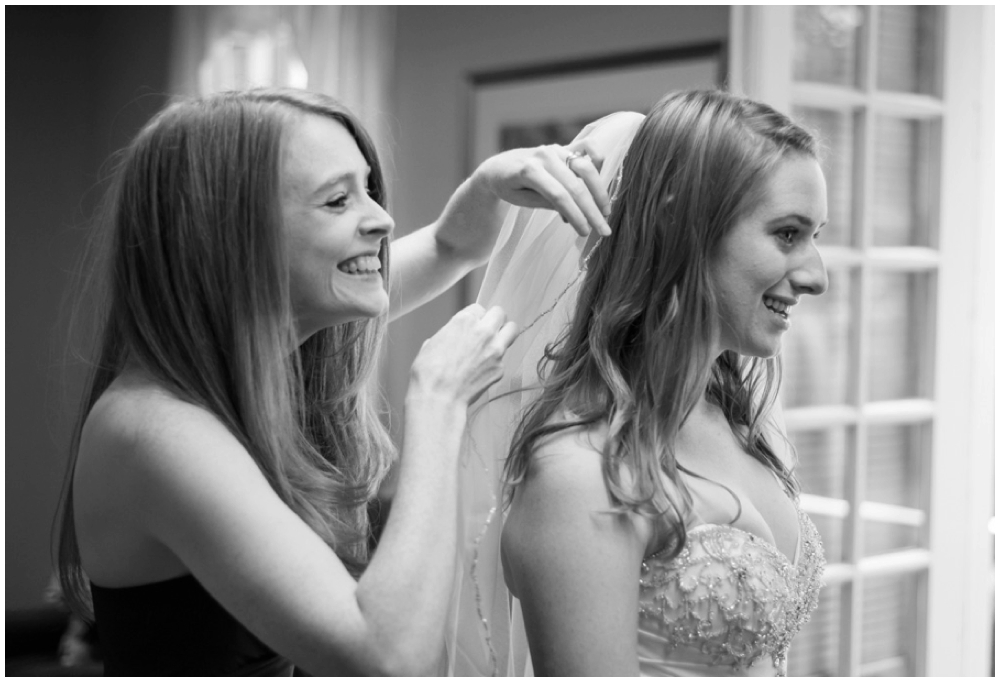 bride putting on veil