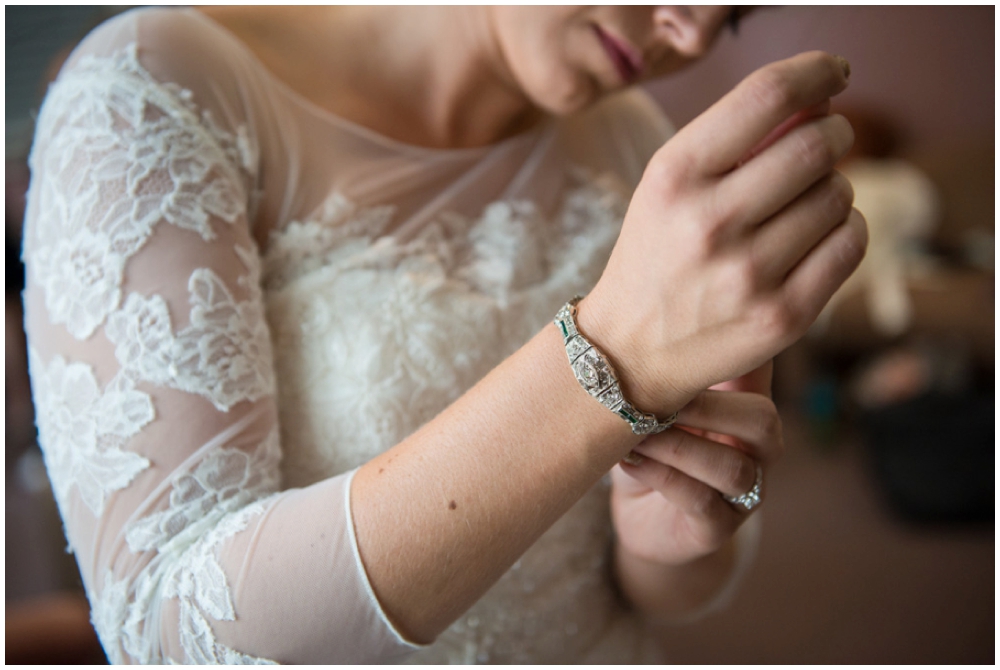 bride putting on jewelry