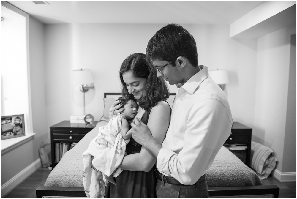 parents with newborn baby girl in home