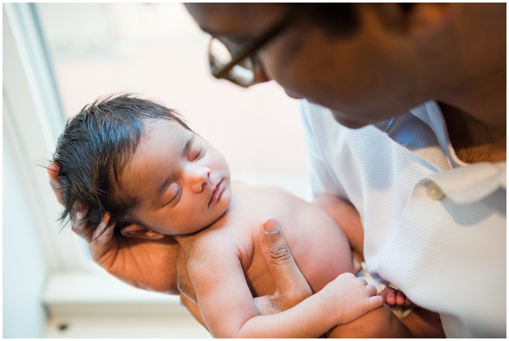 dad with newborn baby girl in home