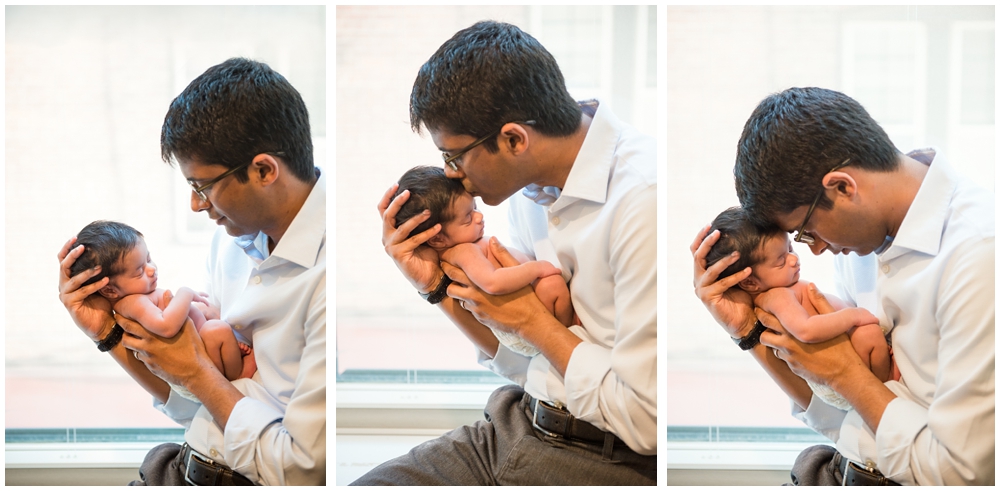 dad with newborn baby girl in home