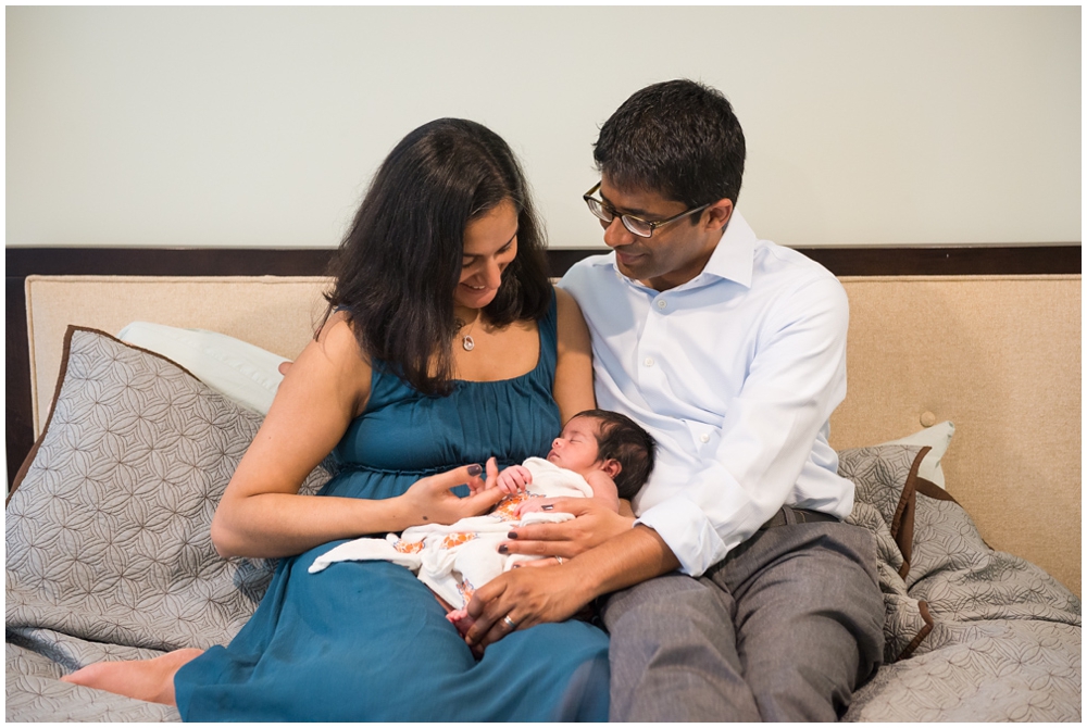 parents with newborn baby girl in home