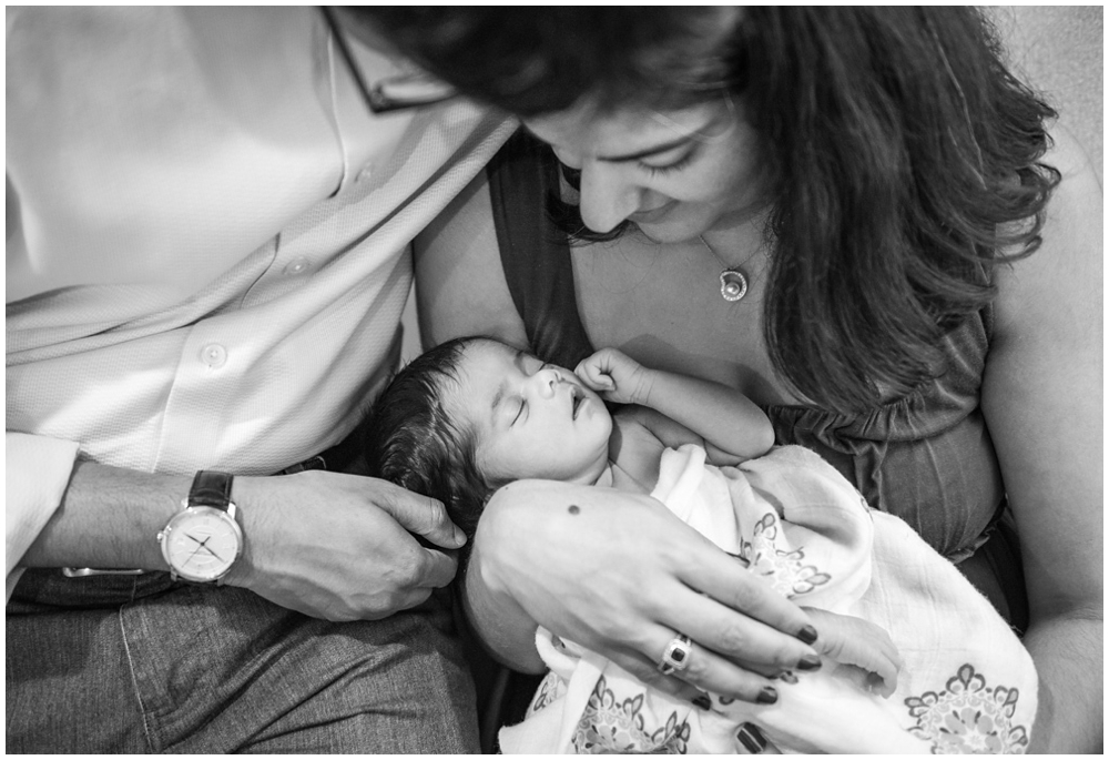 parents with newborn baby girl in home