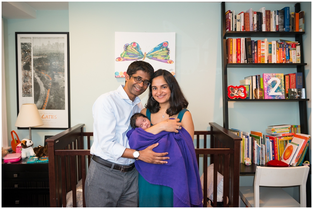 parents with newborn baby girl in home