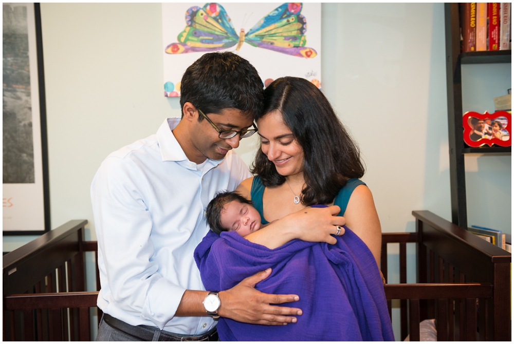 parents with newborn baby girl in home