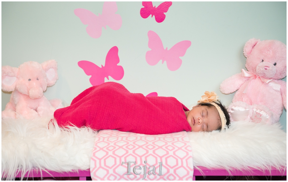 portrait of newborn baby girl with pink butterflies and flowers