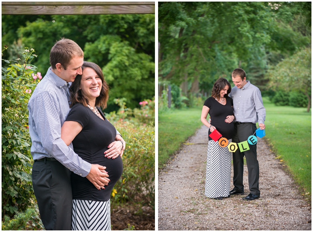 pregnant couple in park with banner