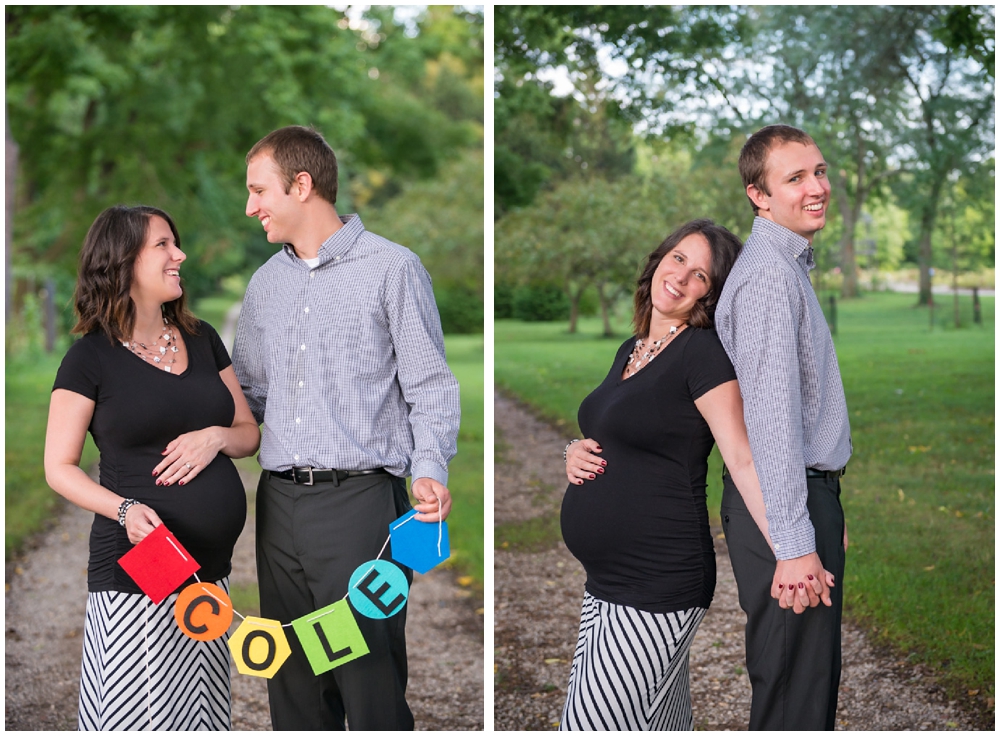 pregnant couple in park with banner