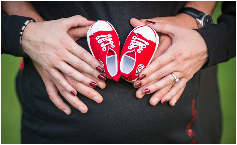 pregnant belly with Ohio State University baby shoes