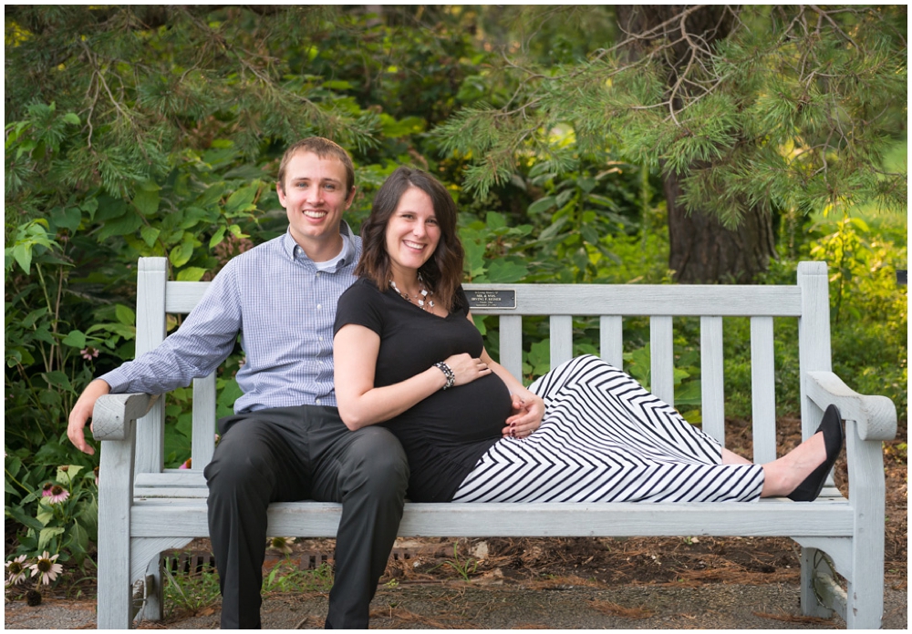 pregnant couple in park on bench