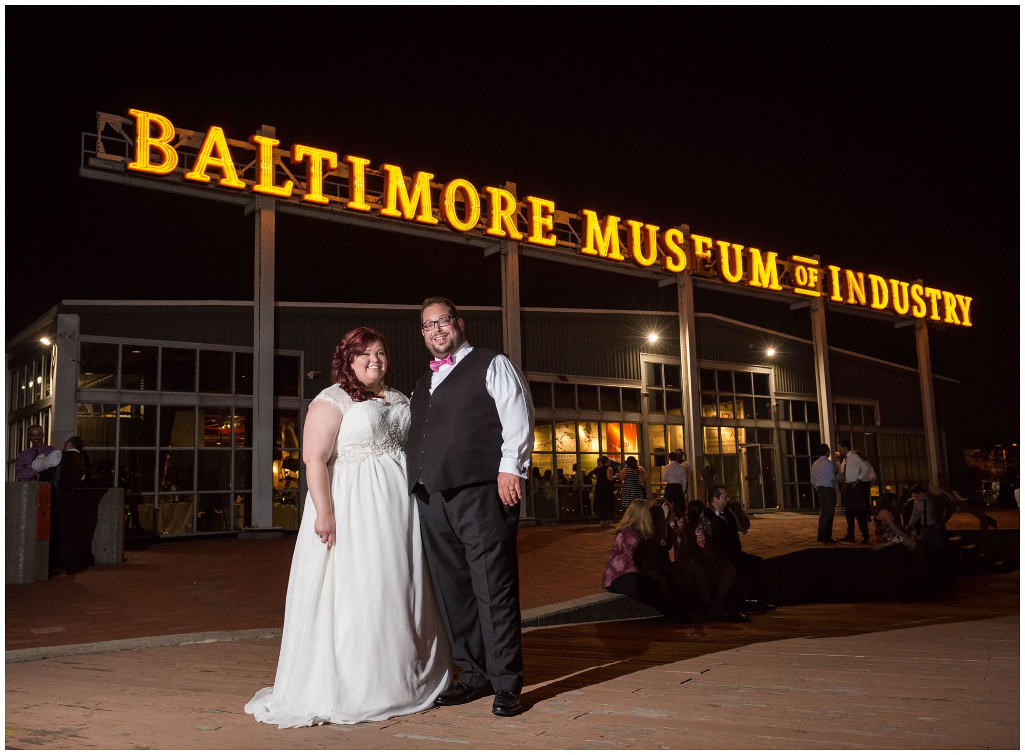 Bride and groom at nighttime in front of Baltimore Museum of Industry