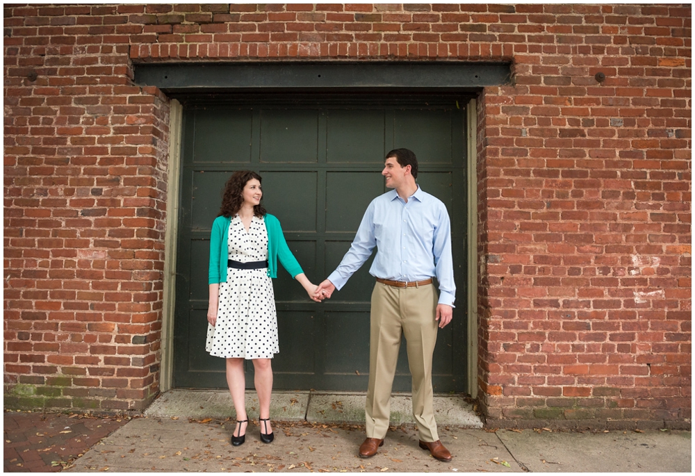 engaged couple with brick background