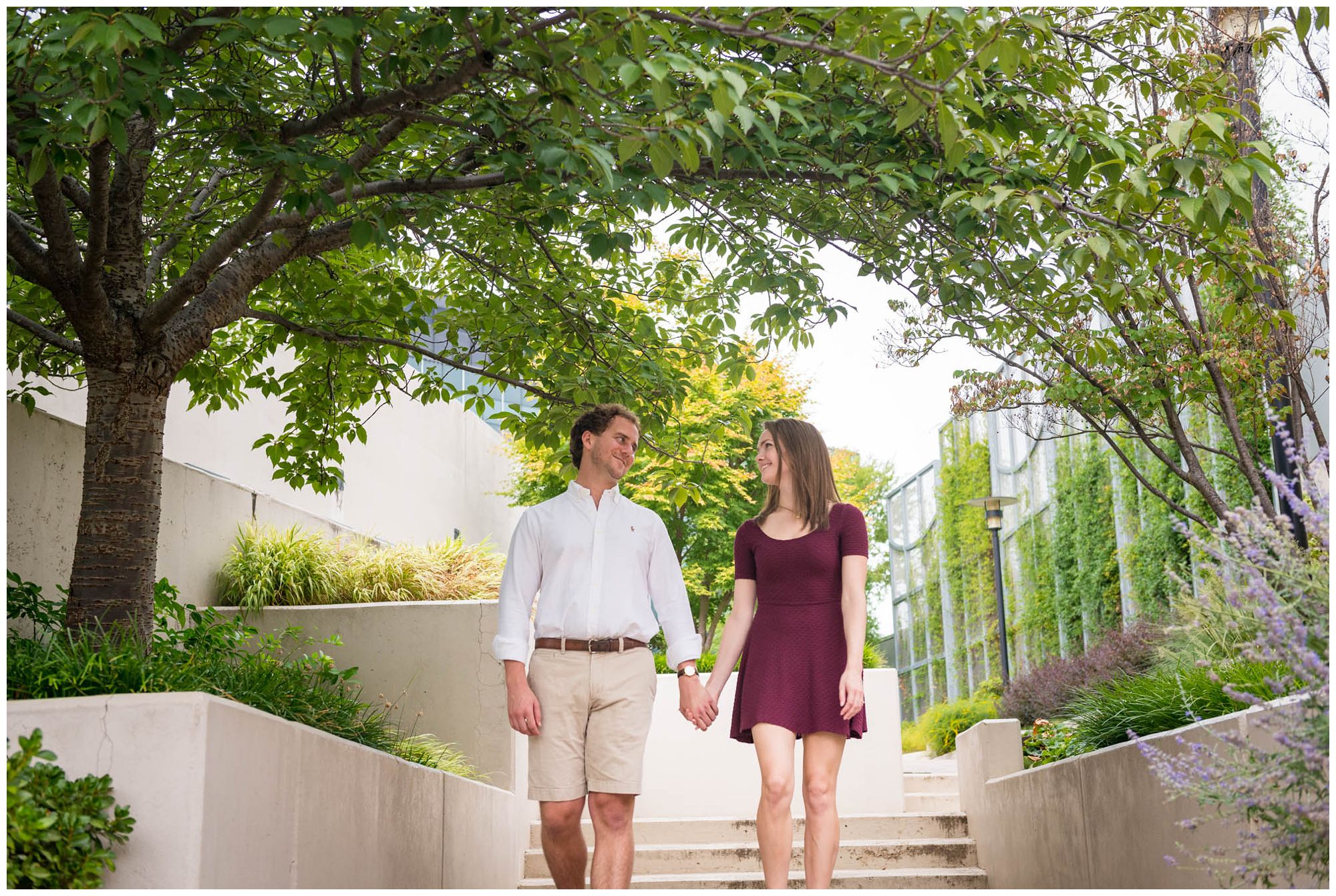 engaged couple walking in urban park