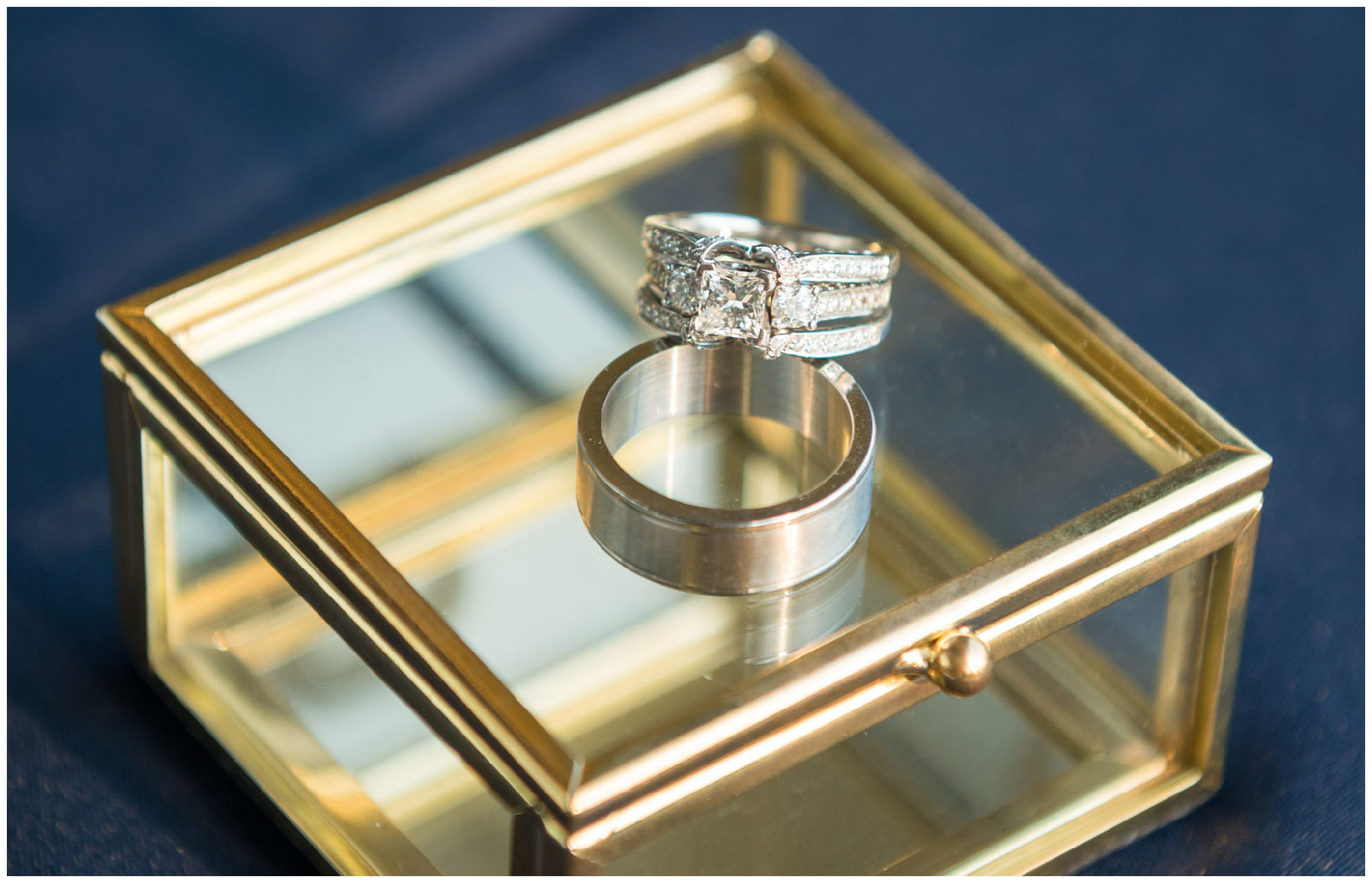 wedding rings on gold mirrored box