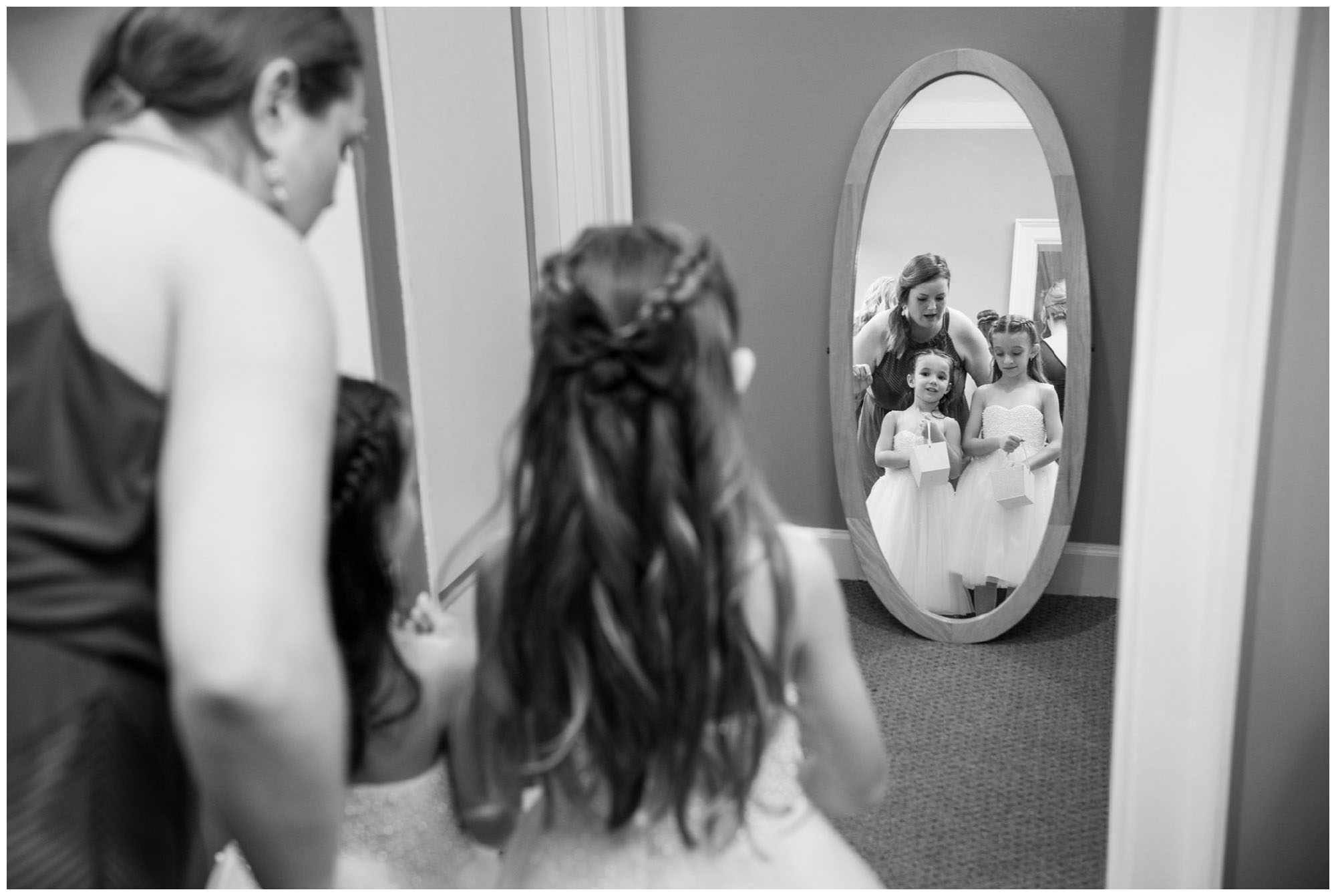 flower girls getting ready in mirror