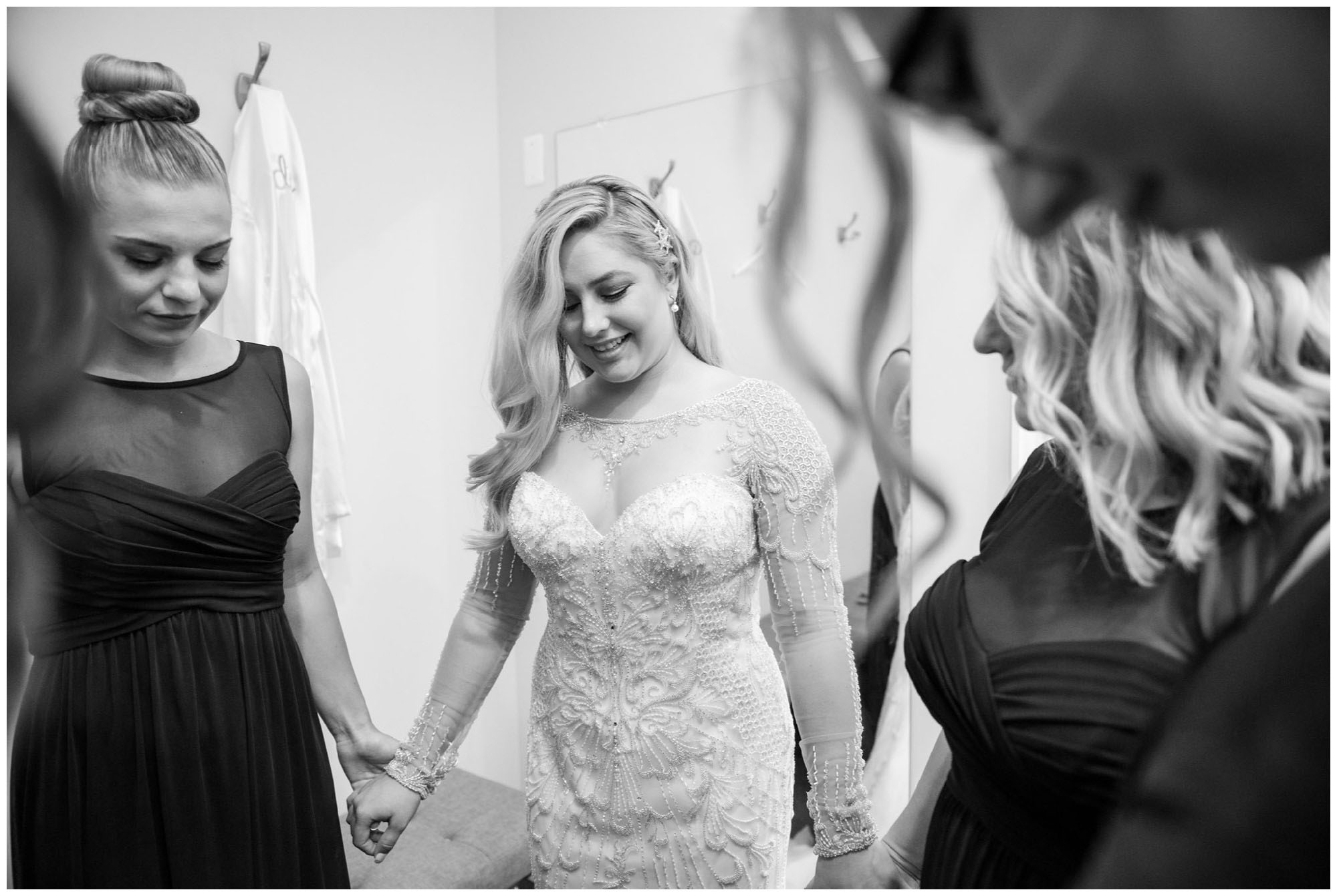 bride and bridesmaids praying before wedding ceremony