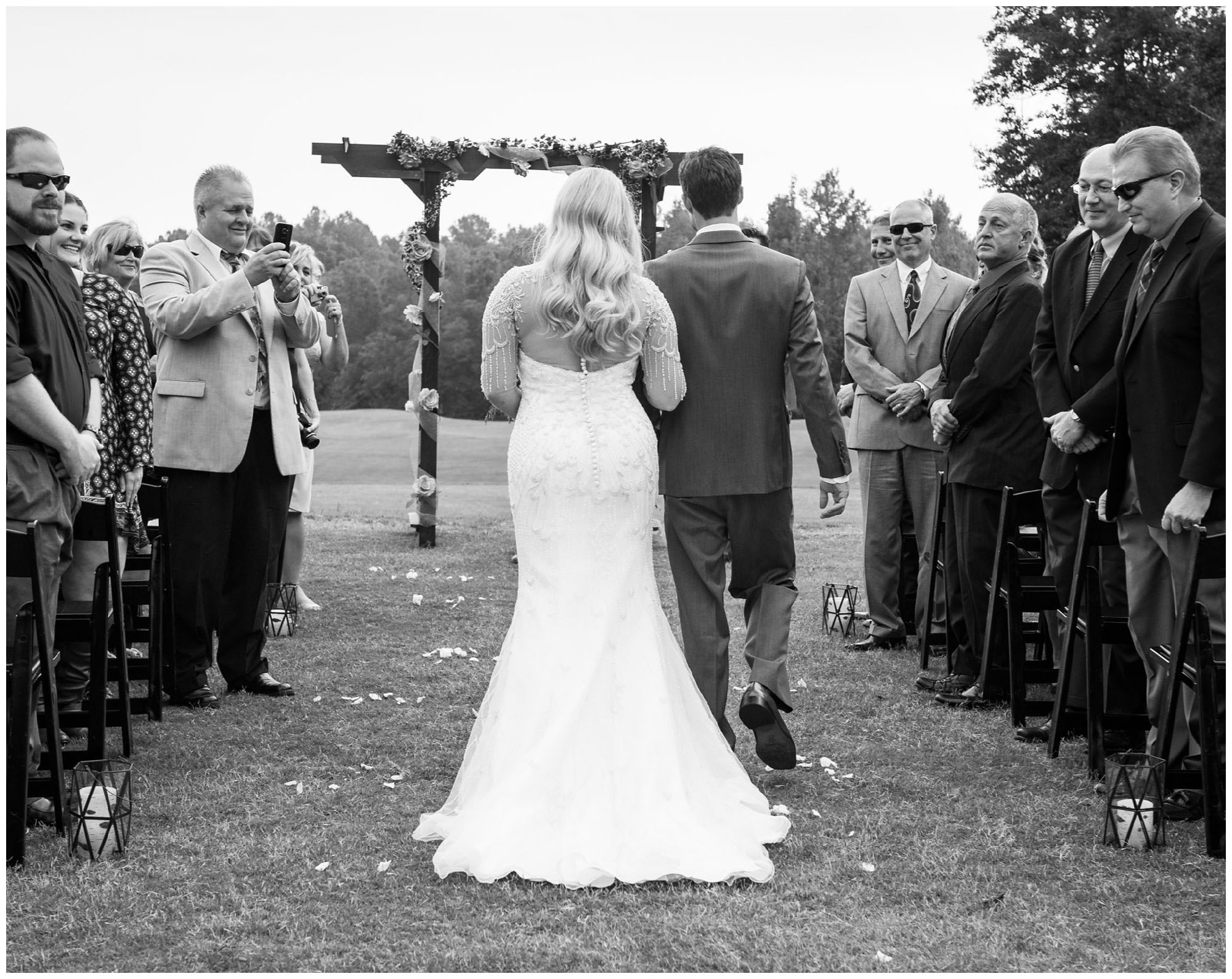 bride walking down the aisle escorted by brother