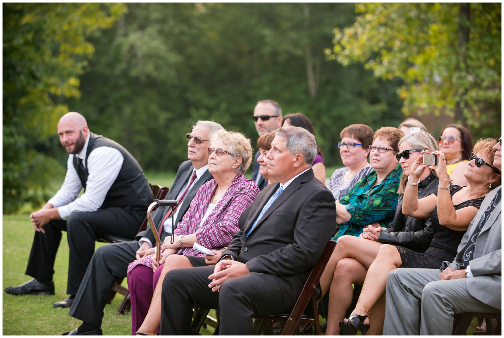 family and friends watching wedding ceremony