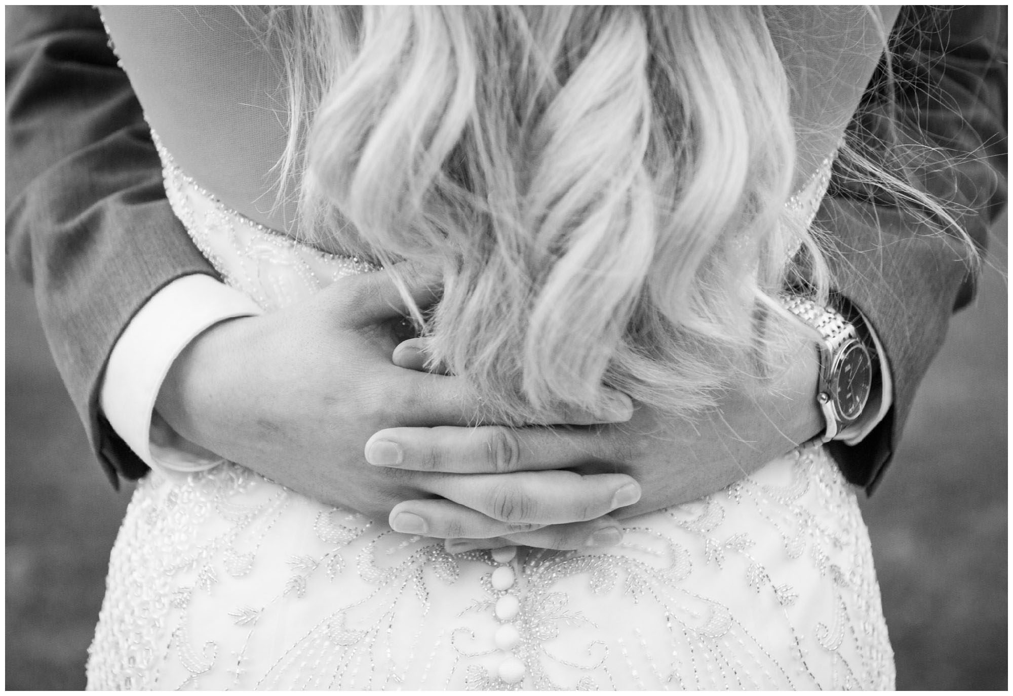 groom embracing bride