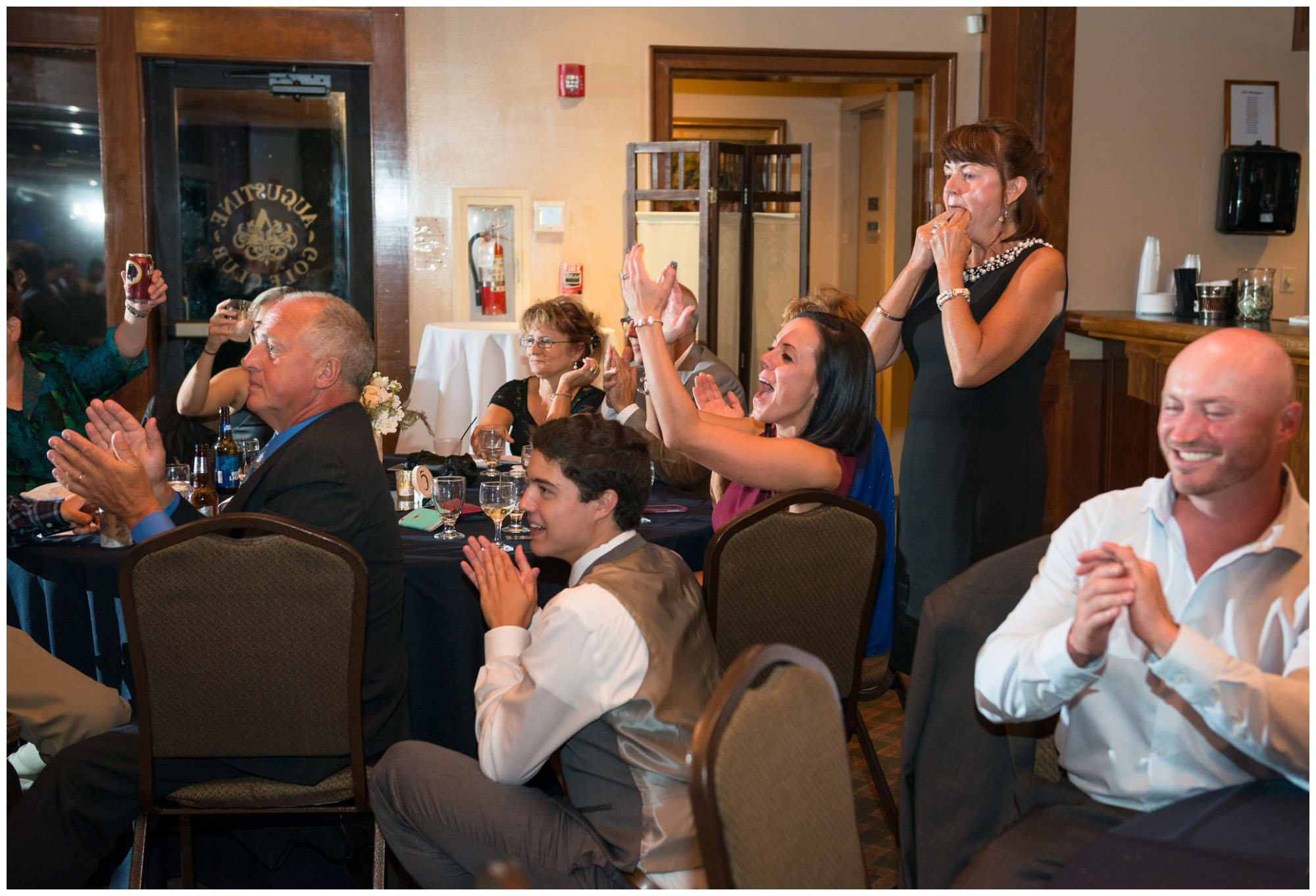 guests react to toasts at wedding reception