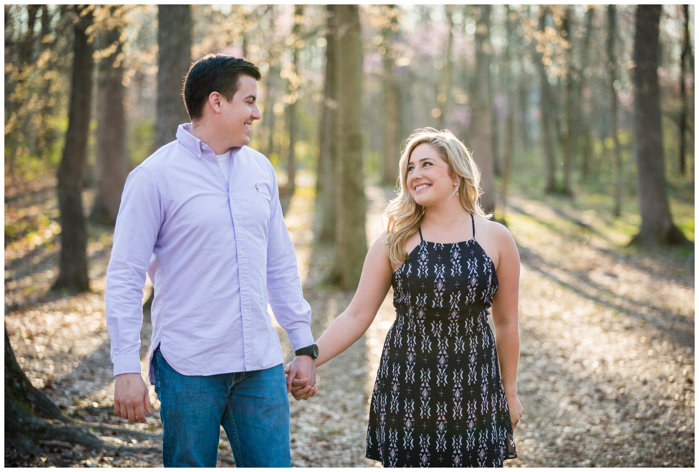 engaged couple in forrest