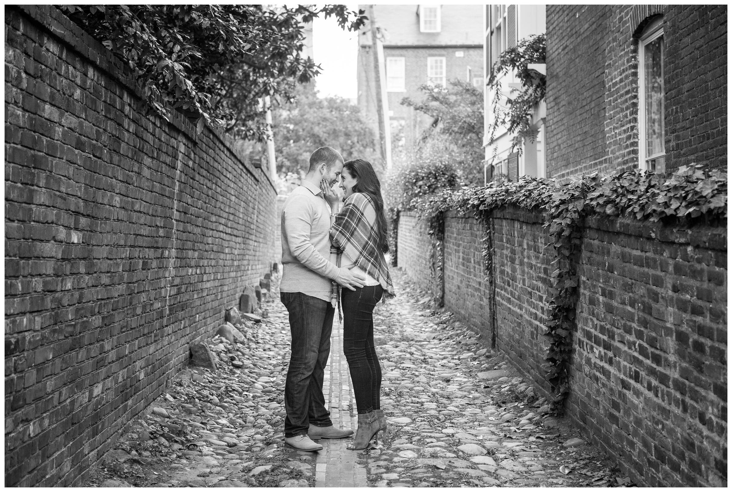 engaged couple in cobblestone alley