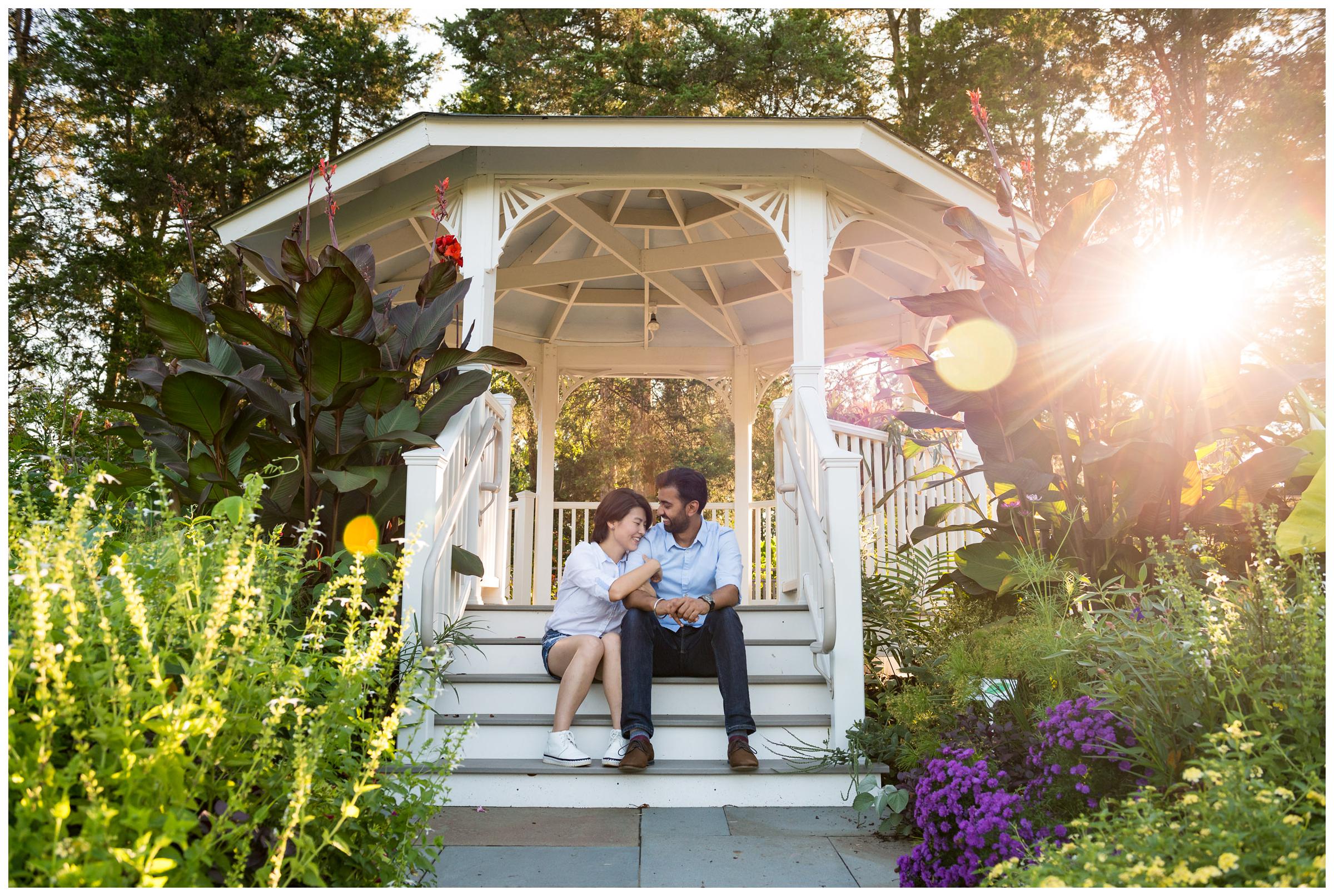 engaged couple in gazebo with sun flare