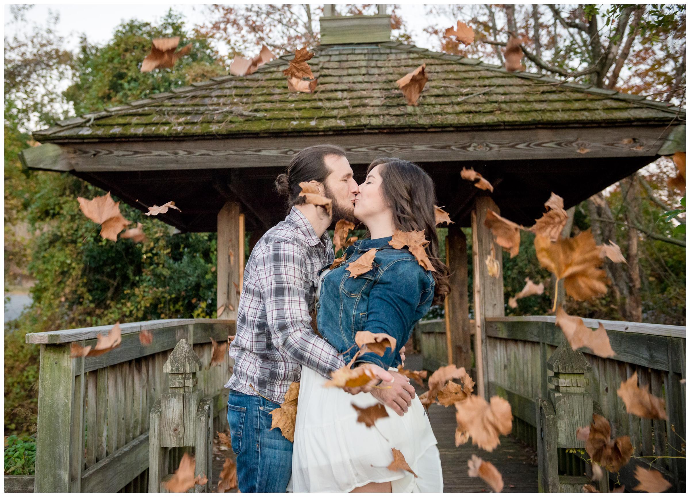 engaged couple throwing leaves