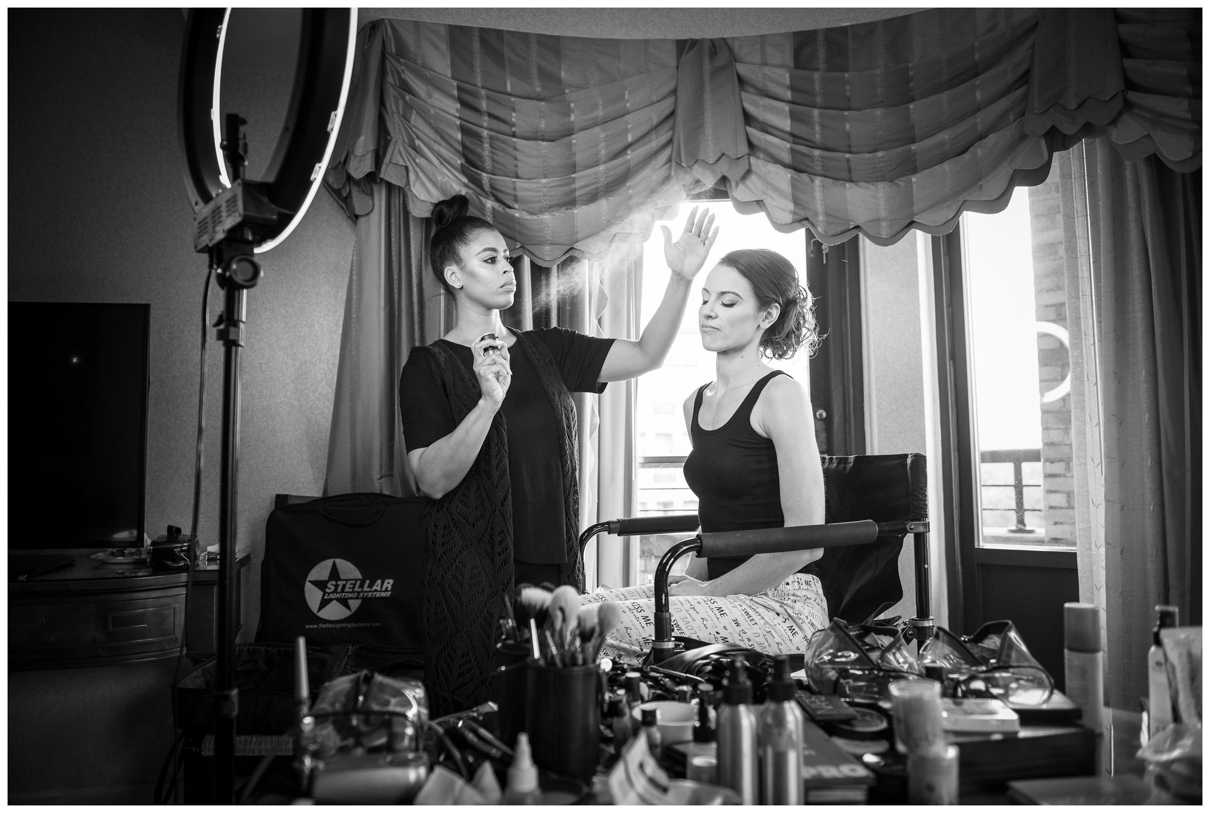 bride getting hair and makeup done