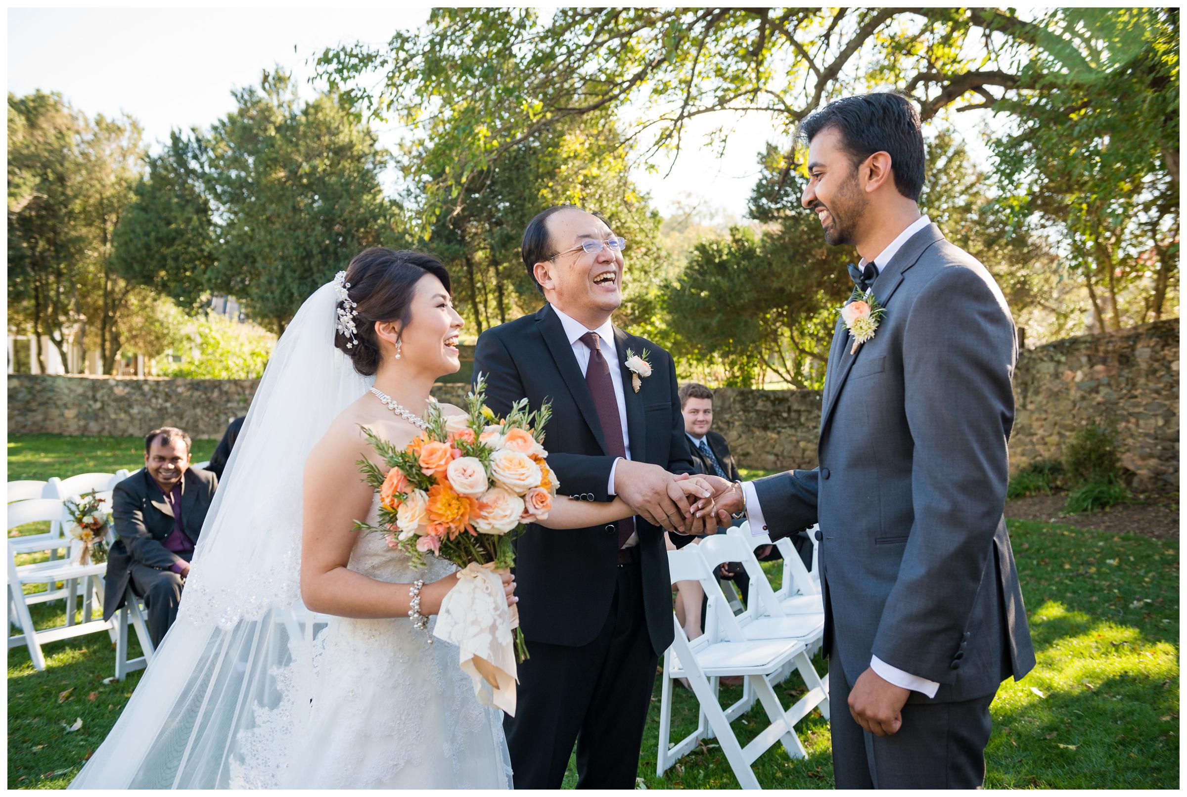 bride's father giving her away during wedding ceremony at Stoneleigh Golf Club in Virginia