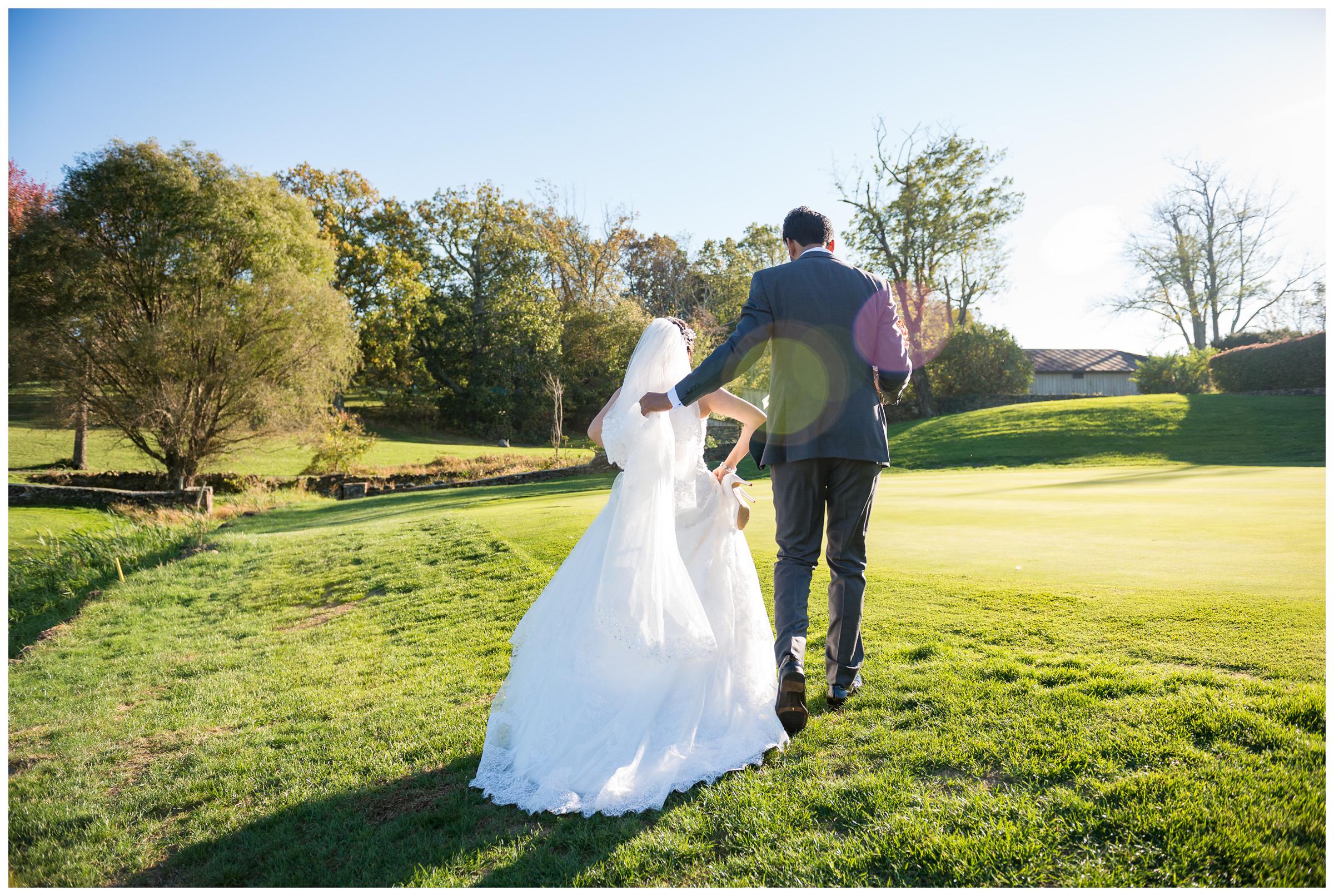 bride and groom walking at Stoneleigh Golf and Country Club in Virginia