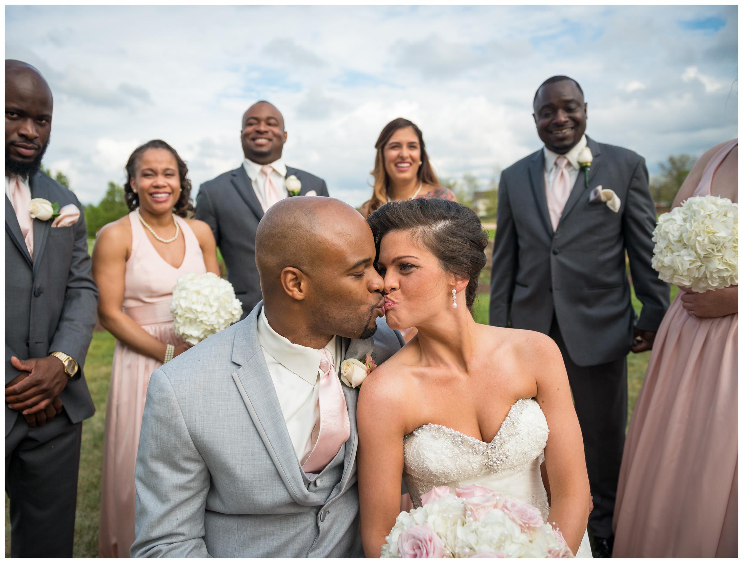 bride and groom surrounded by wedding party