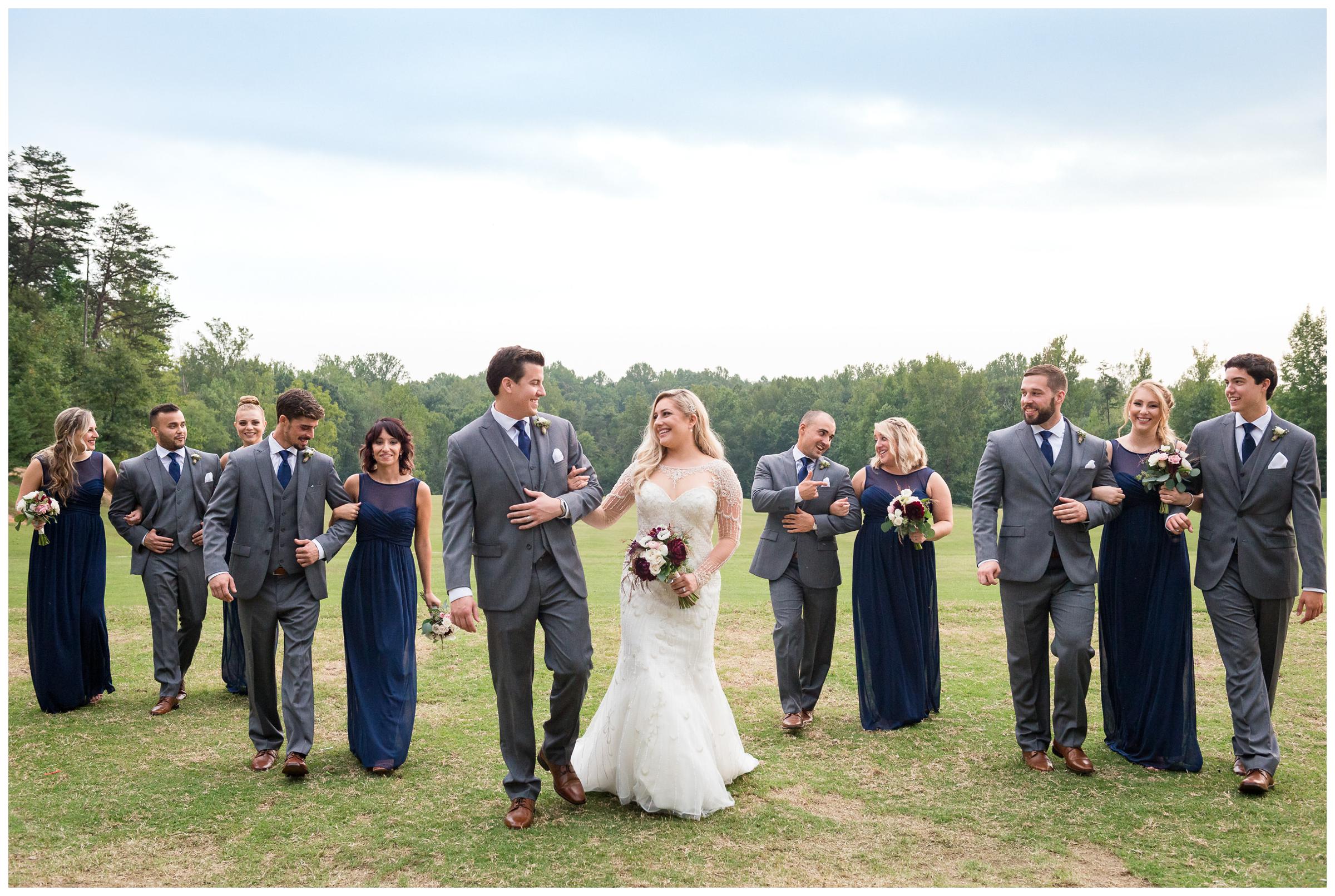 bridal party staggered walking in field